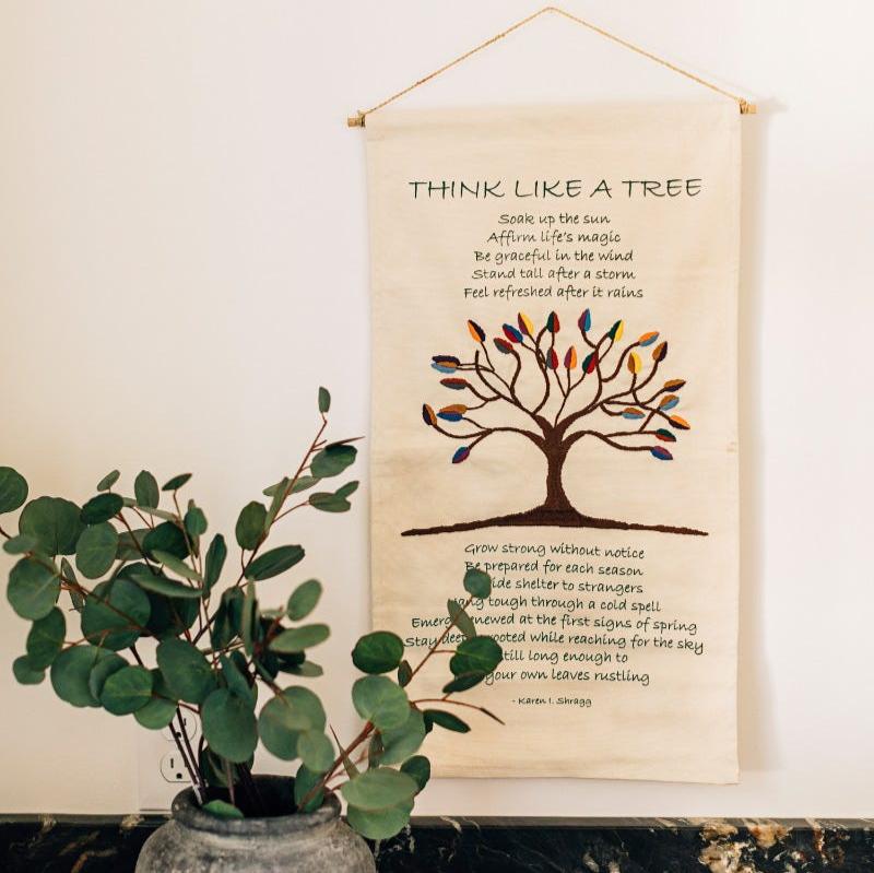 Handcrafted cotton wall hanging featuring the tree poem, perfect for living room decor.