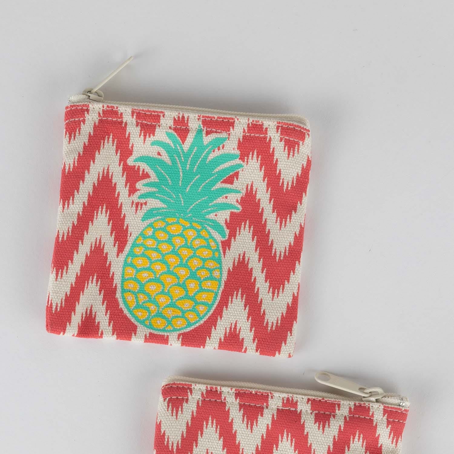 Front view of a handcrafted pineapple coin purse showing zipper and bright design Front view of a handcrafted pineapple coin purse showing zipper and bright design