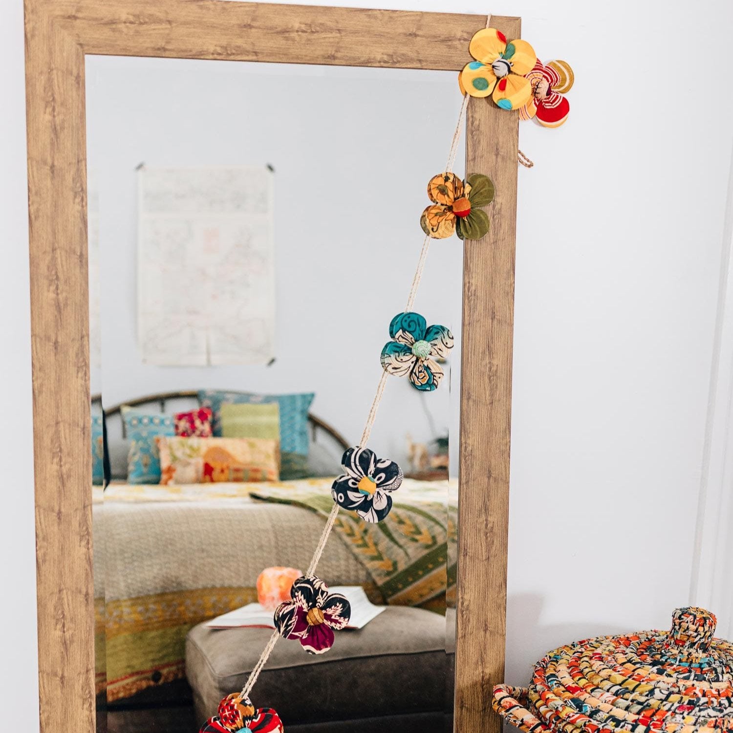 ColorSpun flower garland draped across a rustic mantel — showcasing artisan recycled decor online