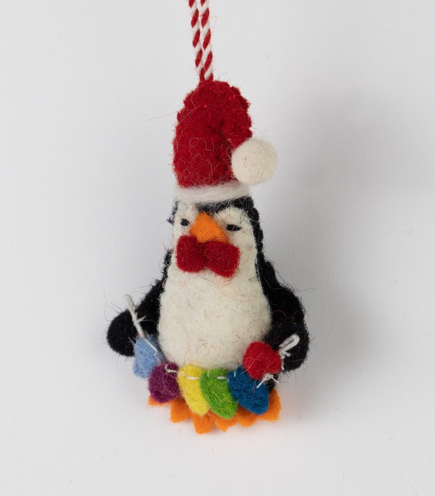 Close-up of artisan penguin Christmas ornament showcasing its intricate felted design.