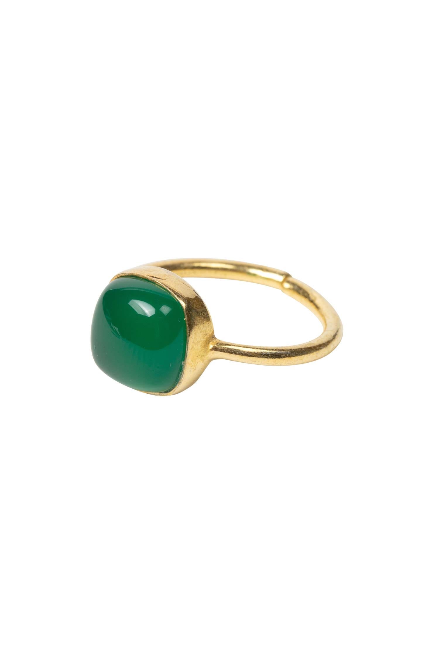 Detailed view of a handcrafted green onyx ring showcasing its vibrant gemstone and intricate band