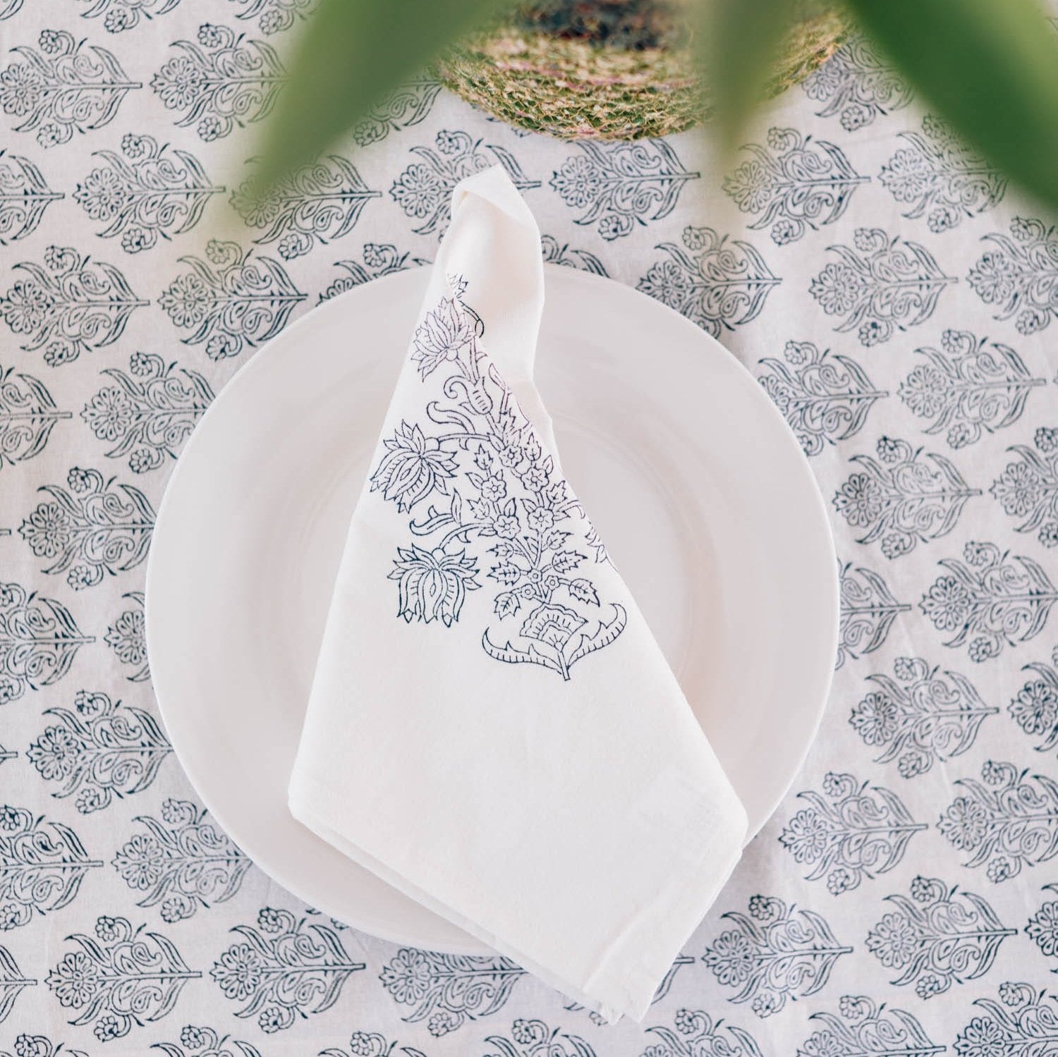 Close-up of artisan hand-printed navy and white handmade napkin