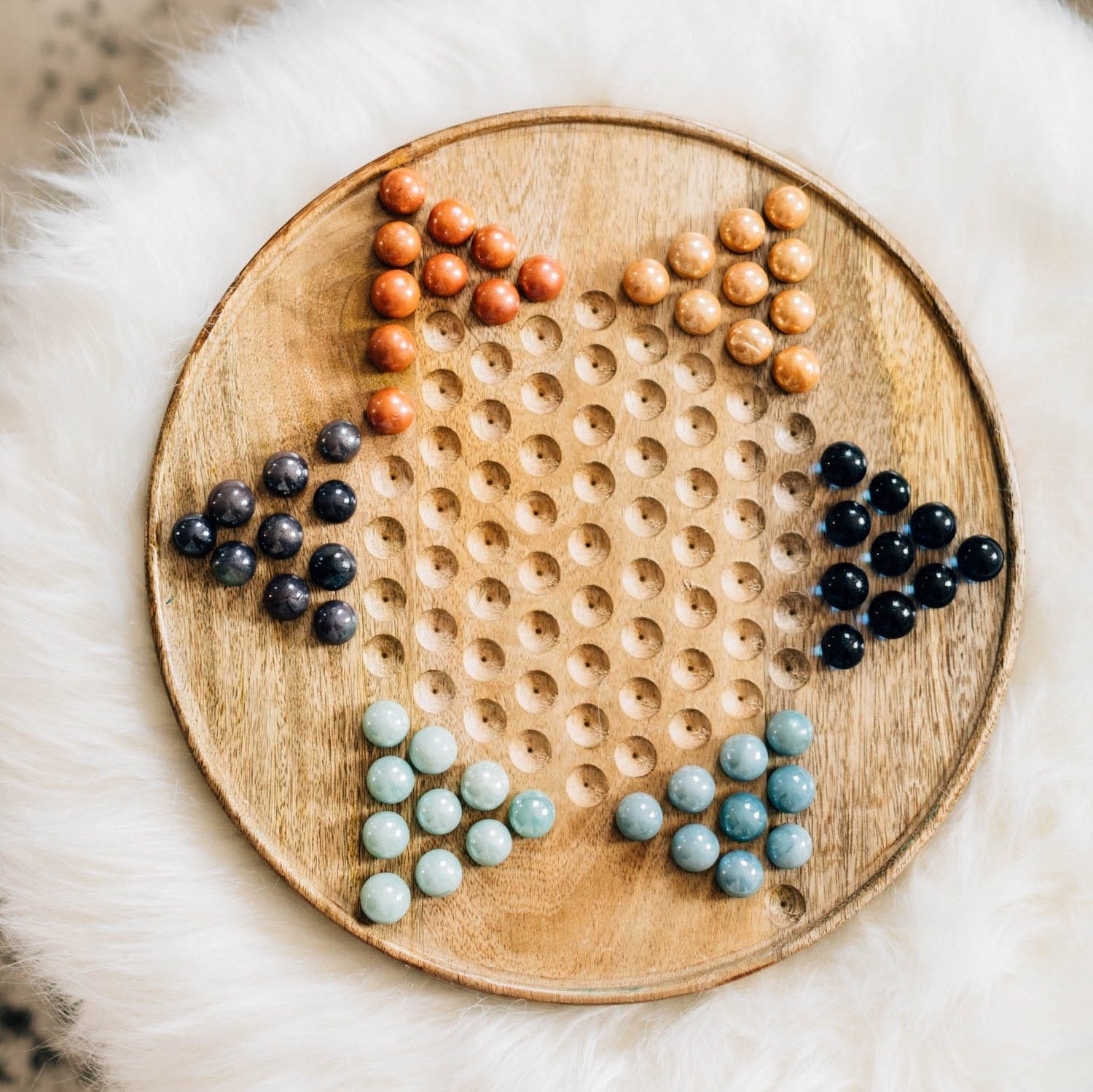 Artisan Star Marble Checkers Set showing vibrant marbles on a classic board game.