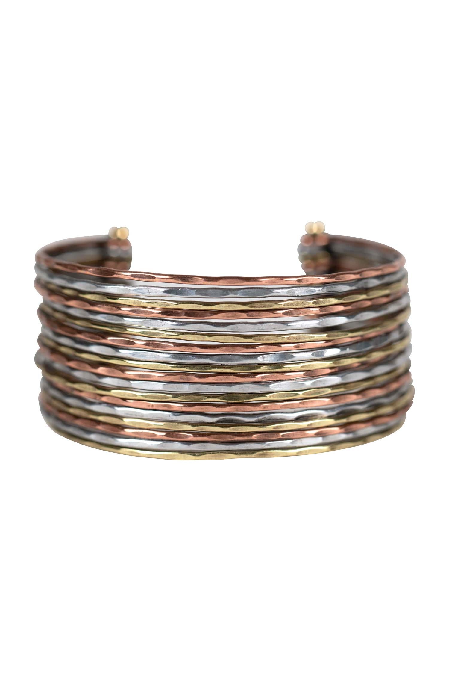 Close-up of Artisan Elegance Cuff Bracelet highlighting the intricate gold, silver, and copper lines.