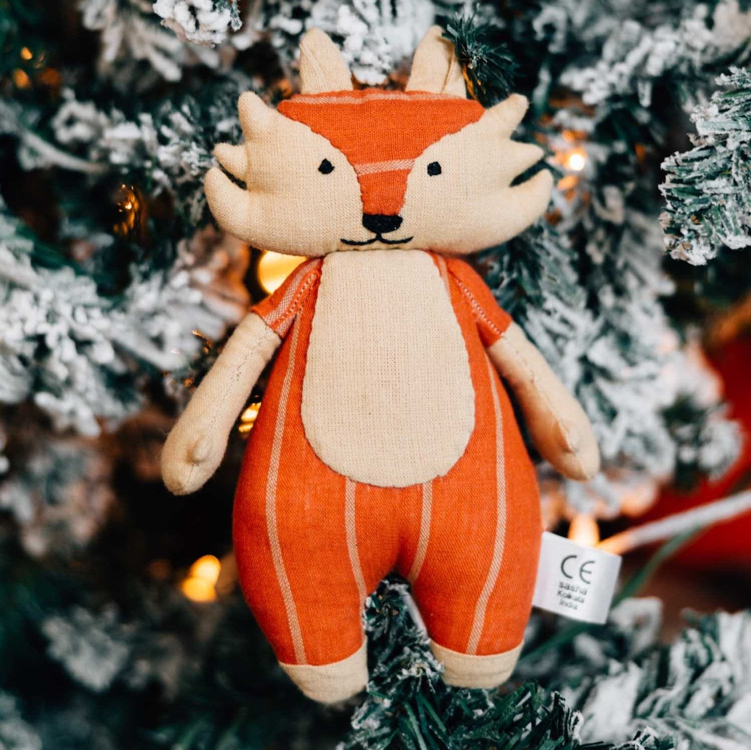 Fair Trade Fox plush toy displayed in a child's room, perfect for playtime.
