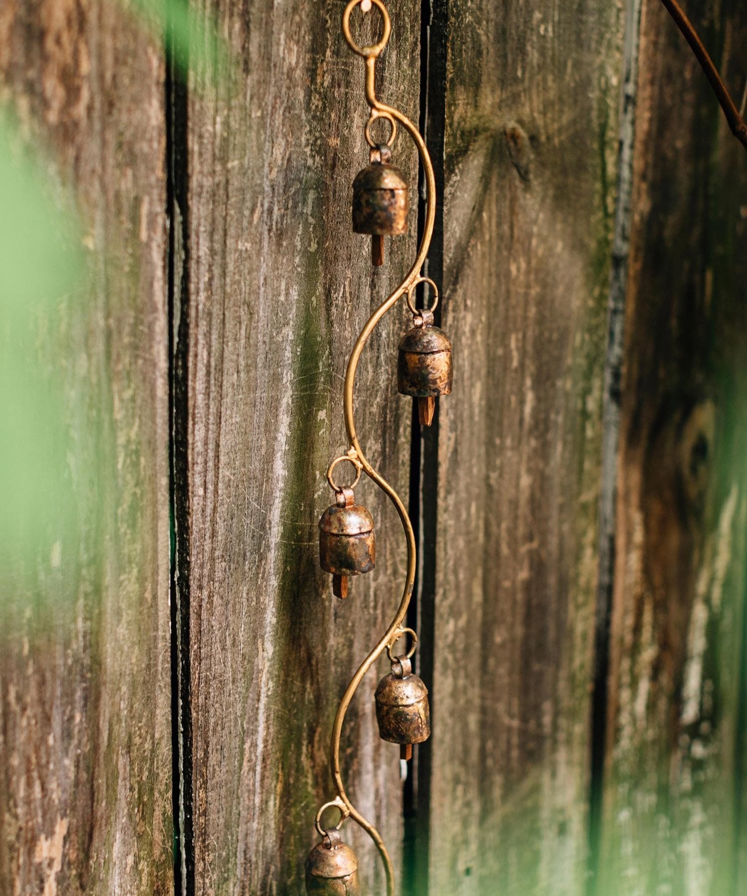 Close-up of recycled metal garden bell with detailed craftsmanship for outdoor decor