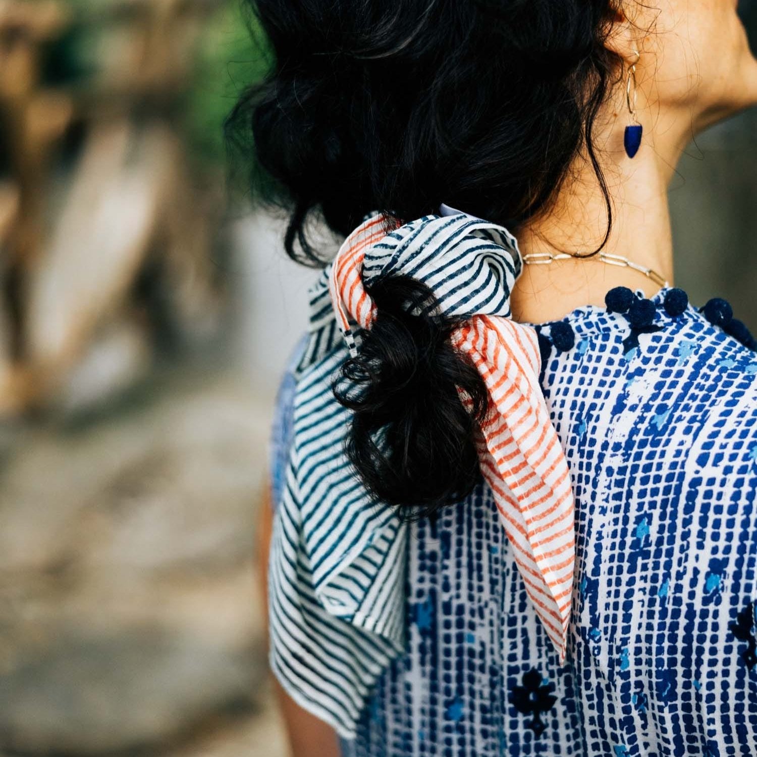 Styled shot of the Painted Stripes Bowtie Scrunchie on a model's ponytail for a trendy summer look