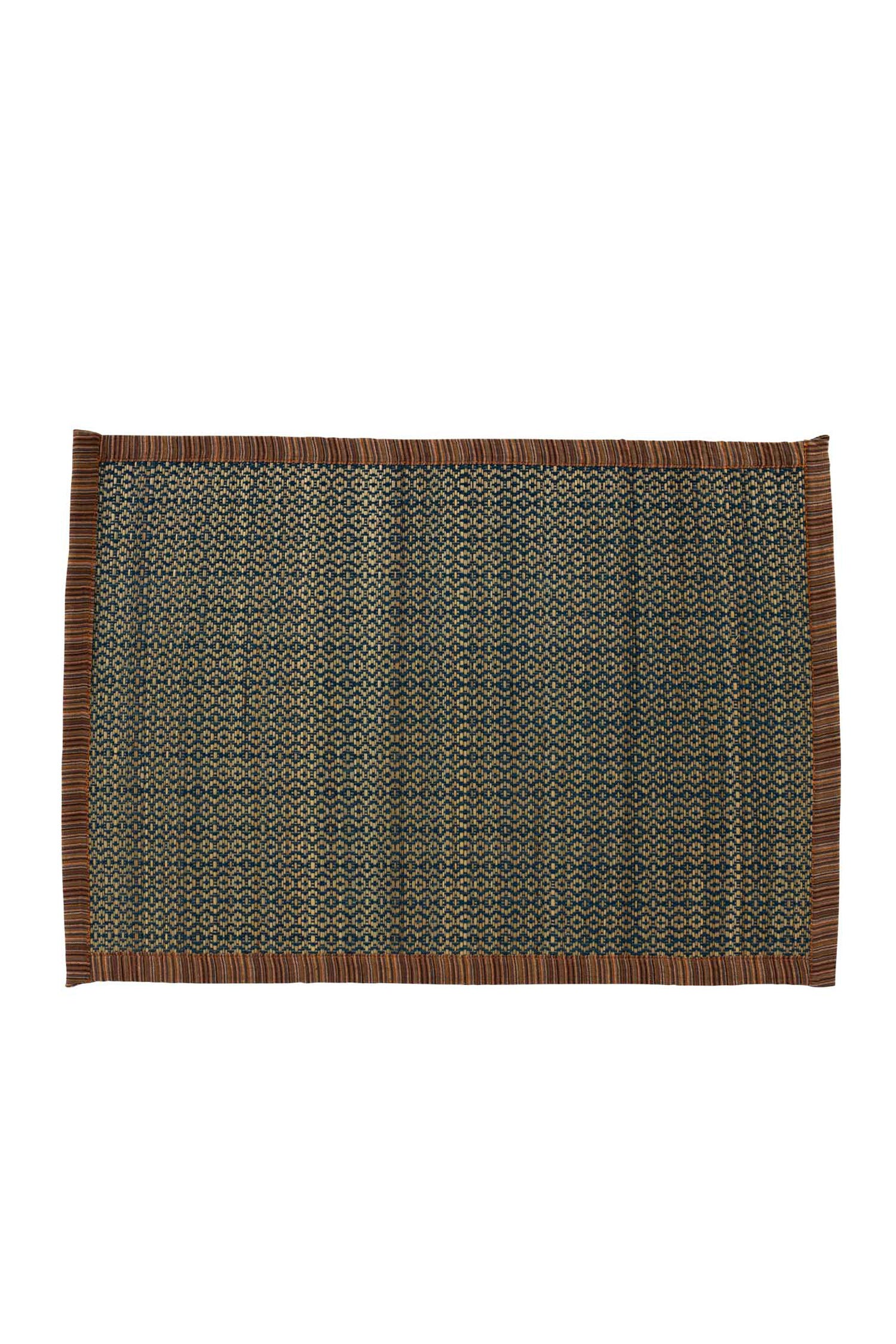Chatu handwoven placemats elegantly set on an outdoor patio table.