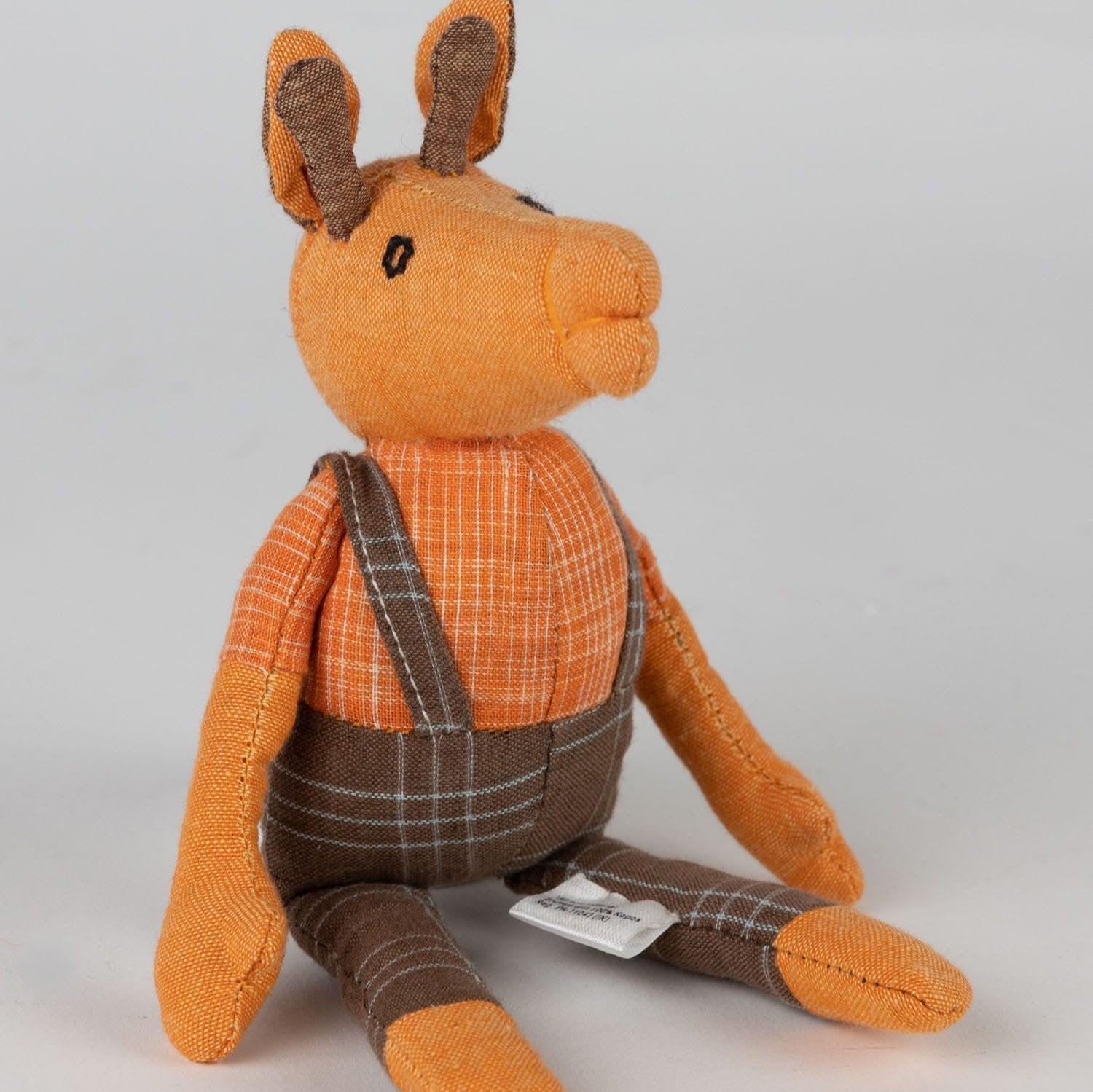 Charming giraffe plush toy in plaid clothing, ideal for imaginative play.