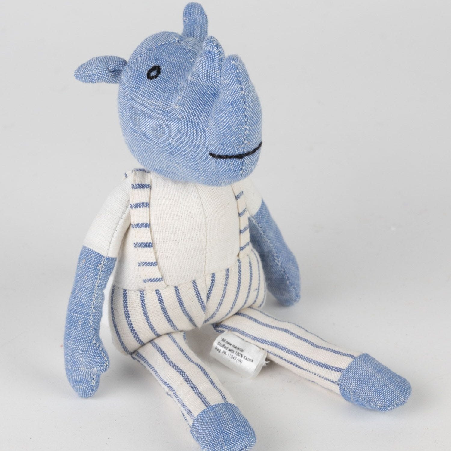 Rover Rhino plush toy in a cozy setting, inviting imaginative play.
