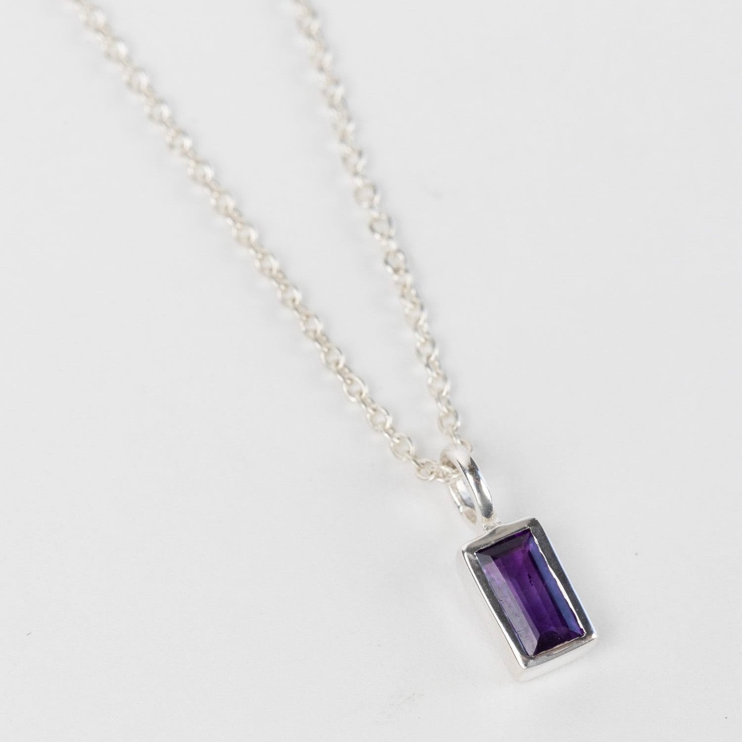Close-up of sterling silver amethyst necklace with detailed gemstone setting
