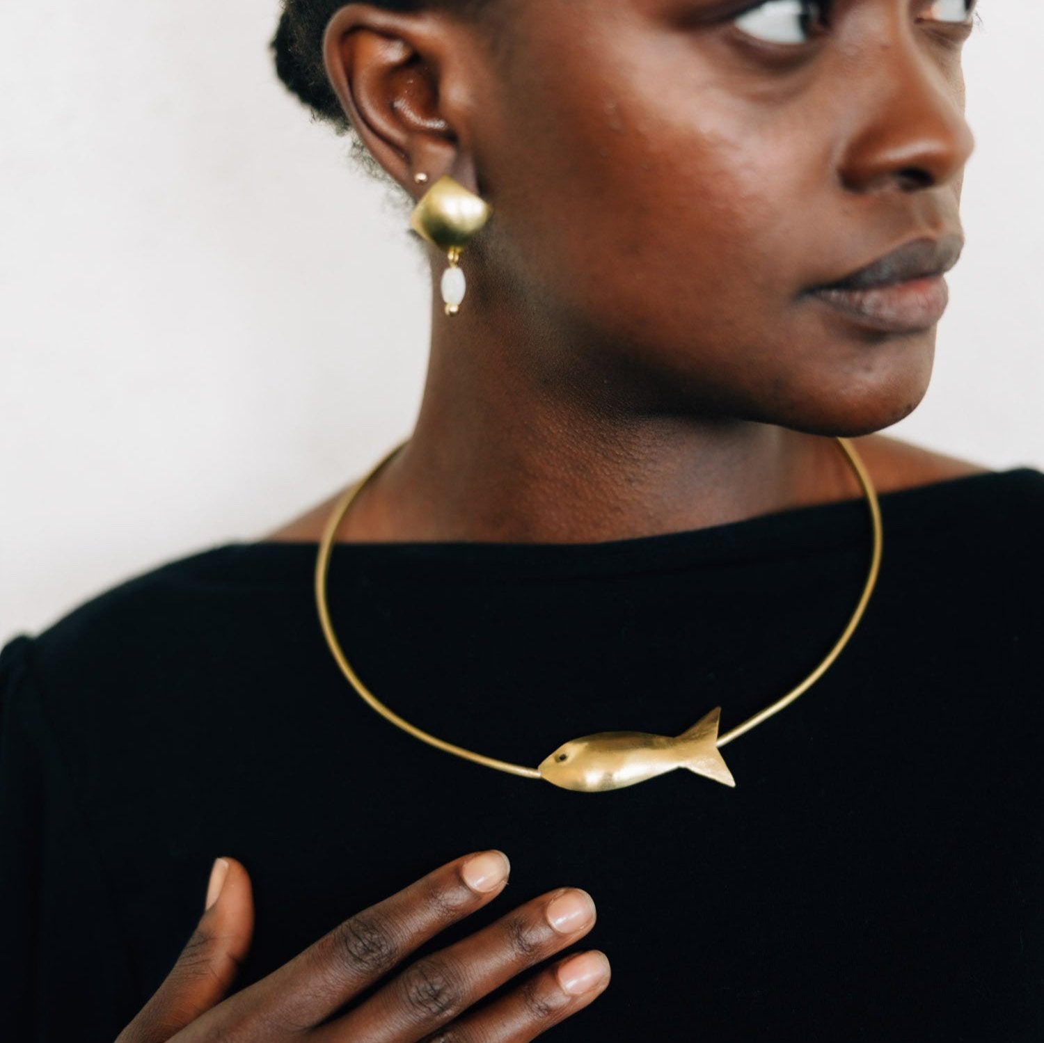 Customizable brass choker worn during a yoga session.