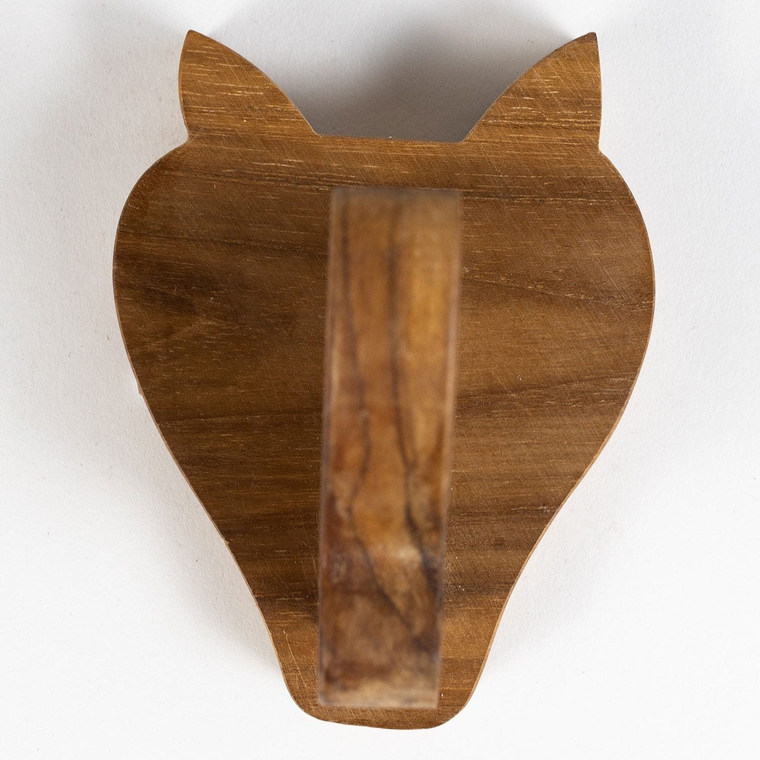 Close-up of the handcrafted teak rhino wall hook showcasing its detailed craftsmanship.