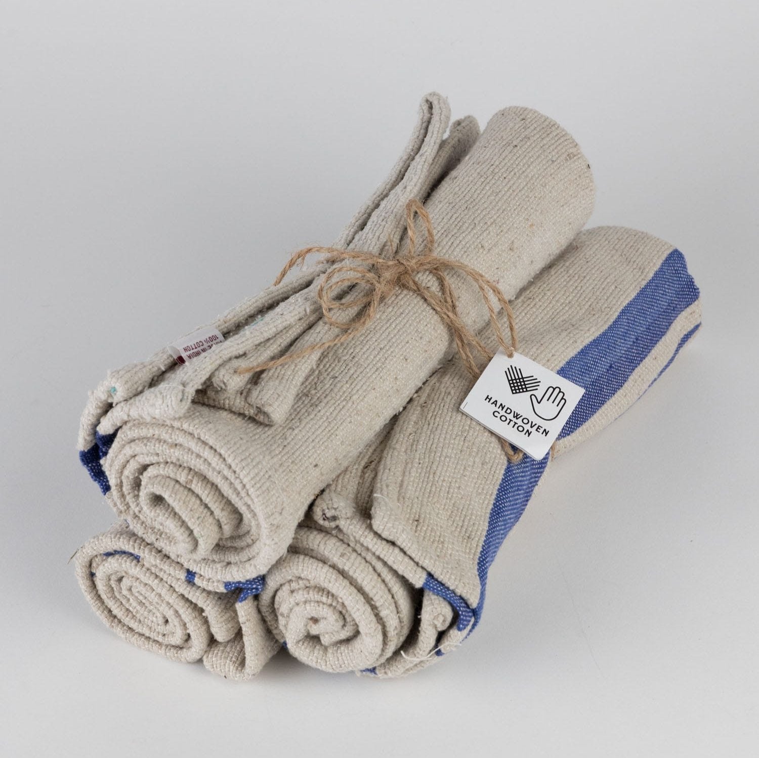 Flat lay of blue stripe tea towels folded neatly on a wooden countertop