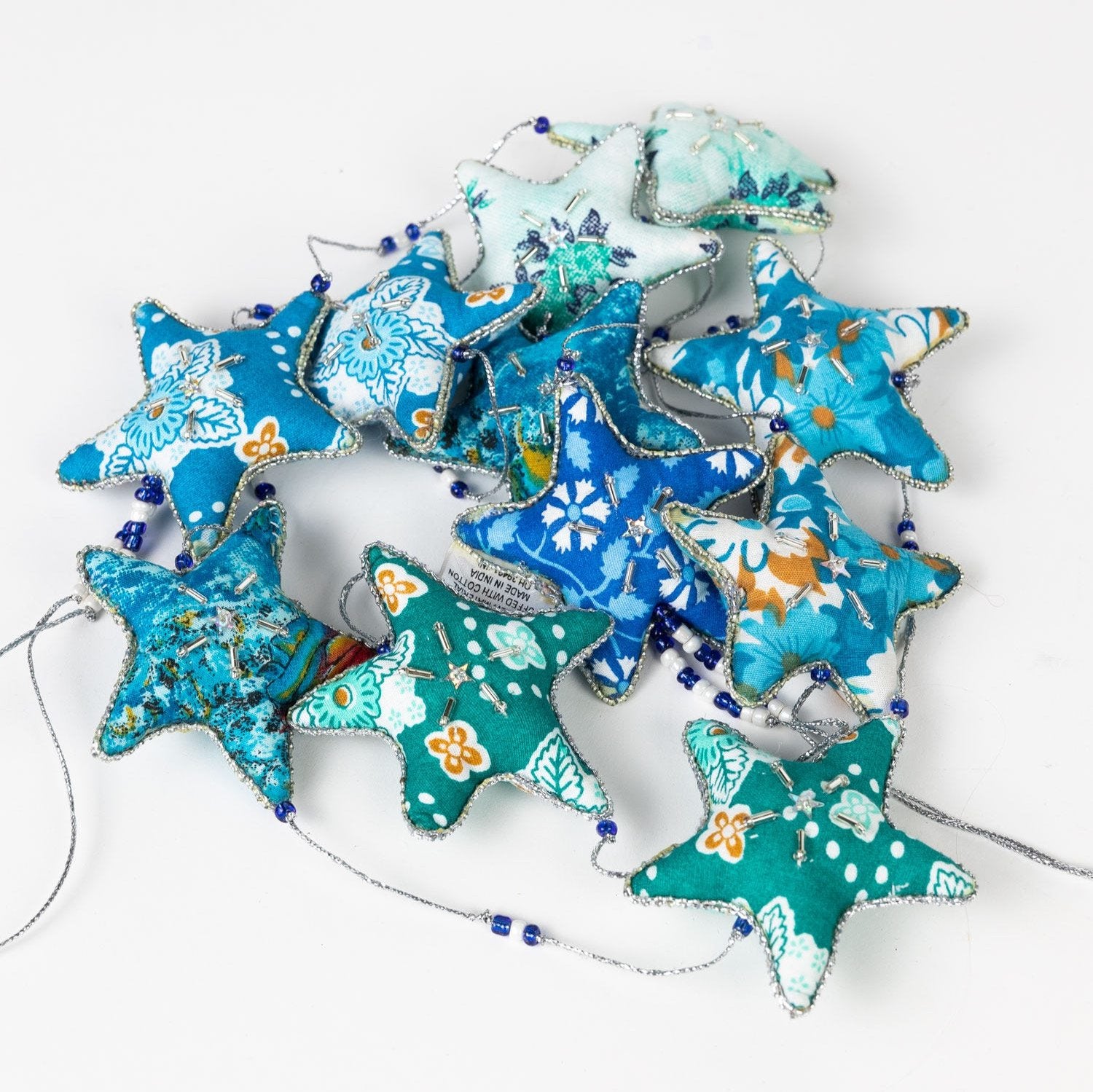 Close-up of embroidered star garland with sequins and silver accents