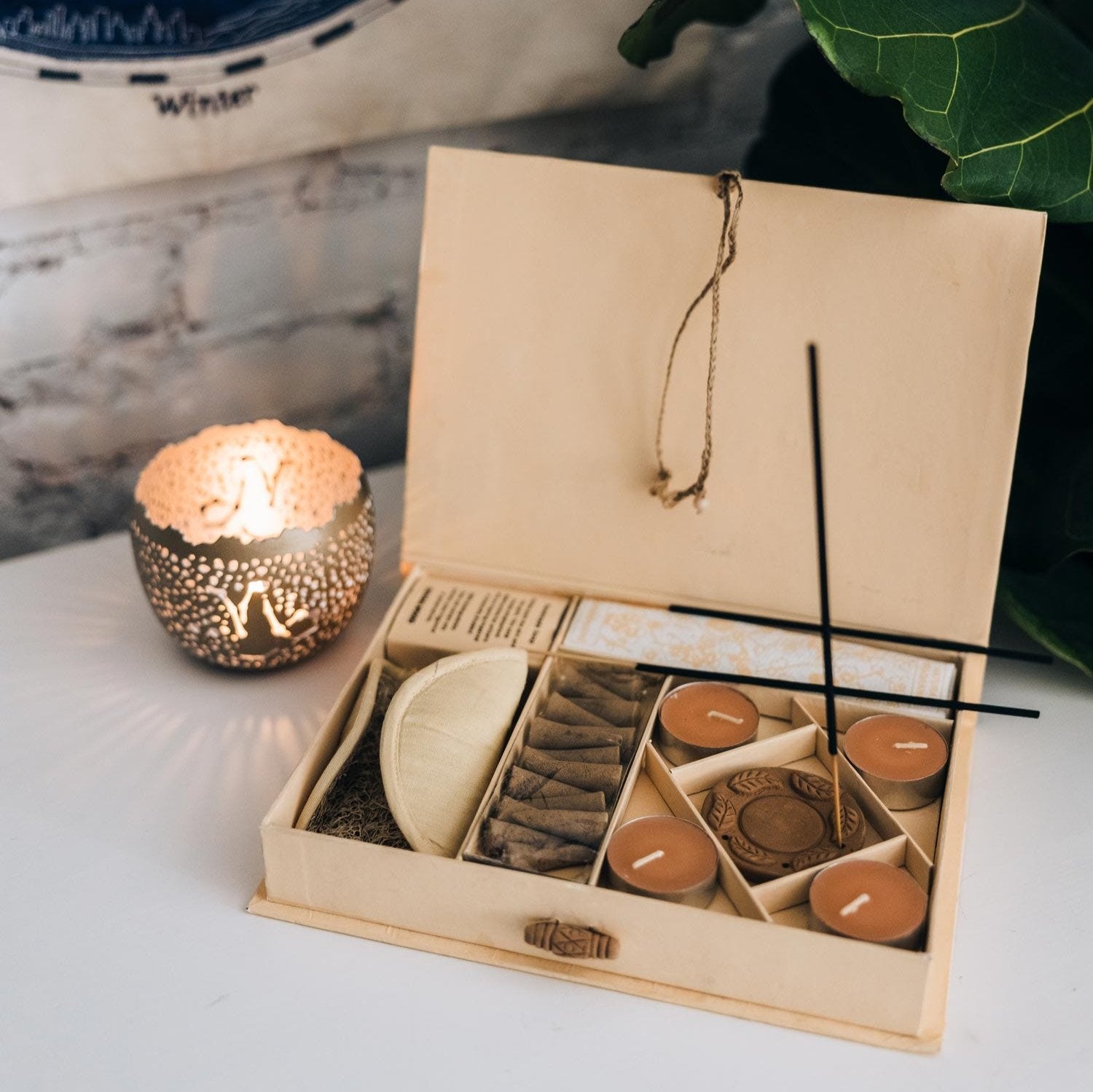 Sandalwood incense sticks and terracotta holder arranged for a serene ambiance.