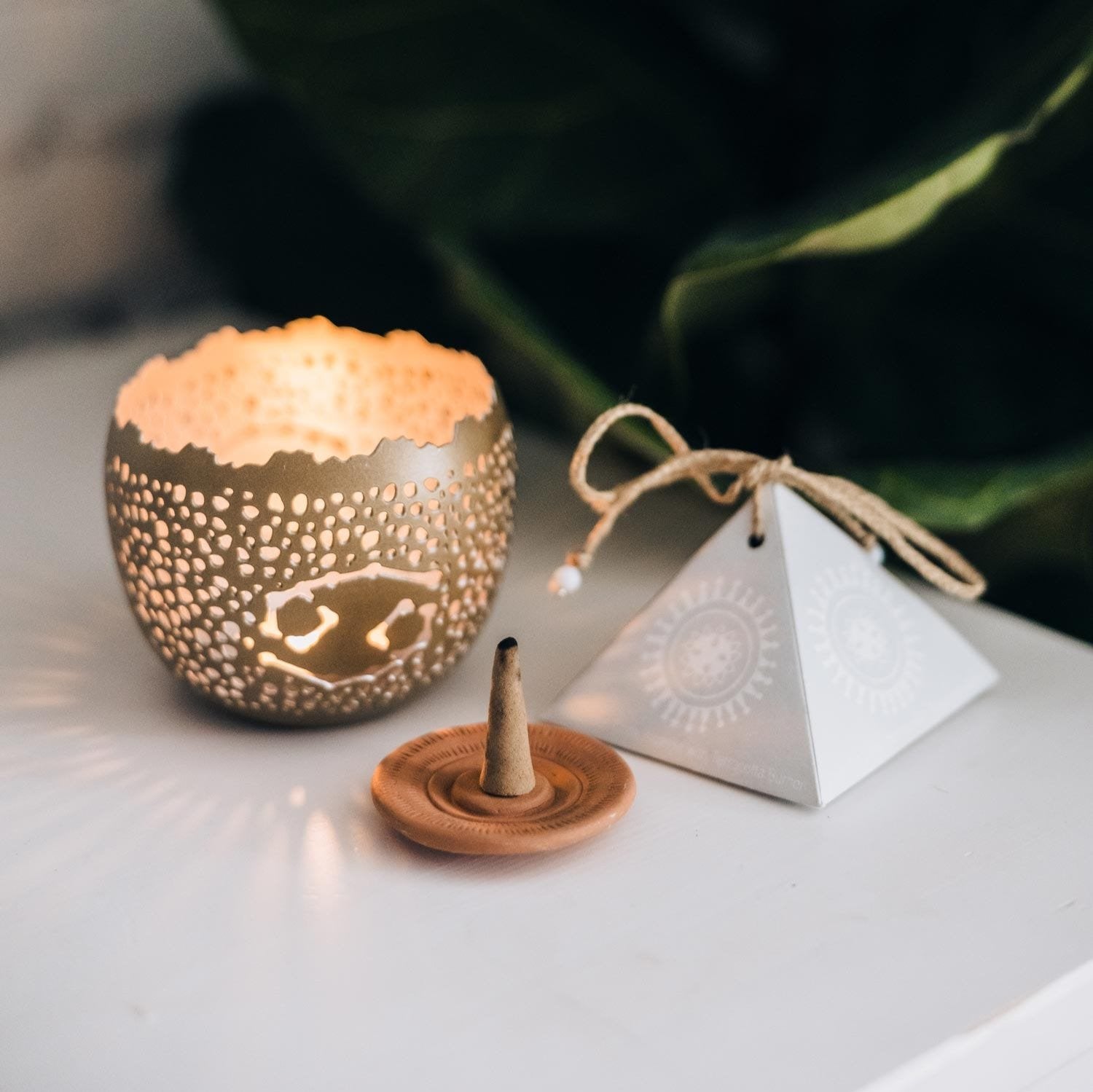 Lavender incense cones with terracotta plate on a wooden table for relaxation.
