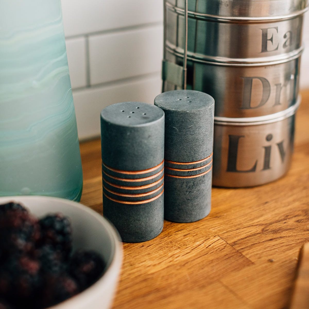 Luxury carved stone salt and pepper set displayed elegantly on a dining table.