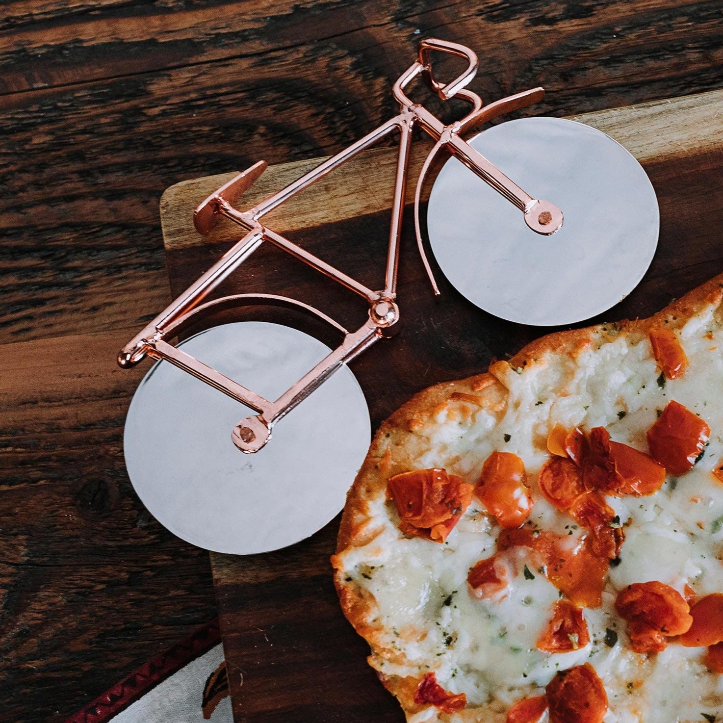 Cyclist's Delight Pizza Cutter from a top view, showcasing its unique bicycle design.
