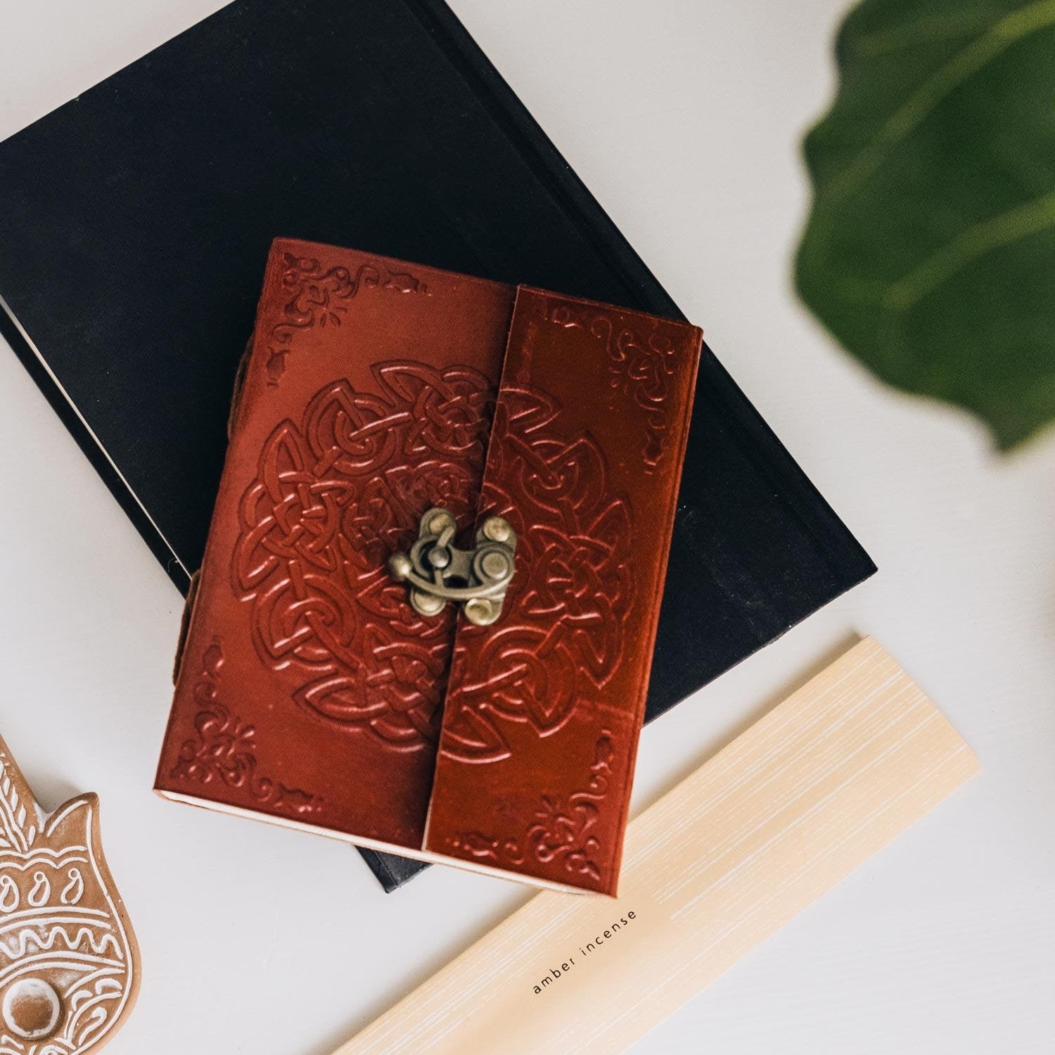 Eternal Weave Leather Journal with open pages showcasing handmade paper, perfect for writing.