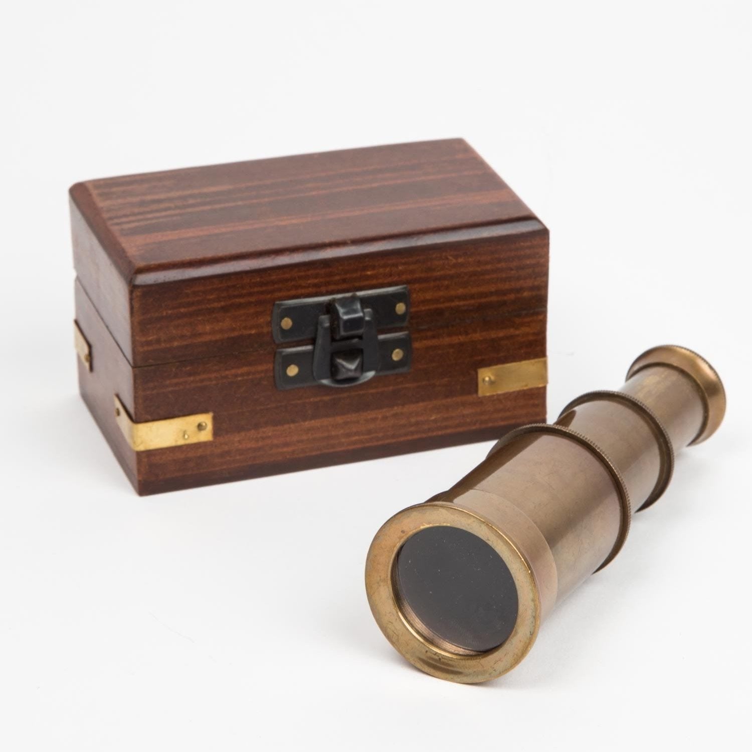 Artisan mini telescope with box displayed on a wooden surface, showcasing its detailed craftsmanship.