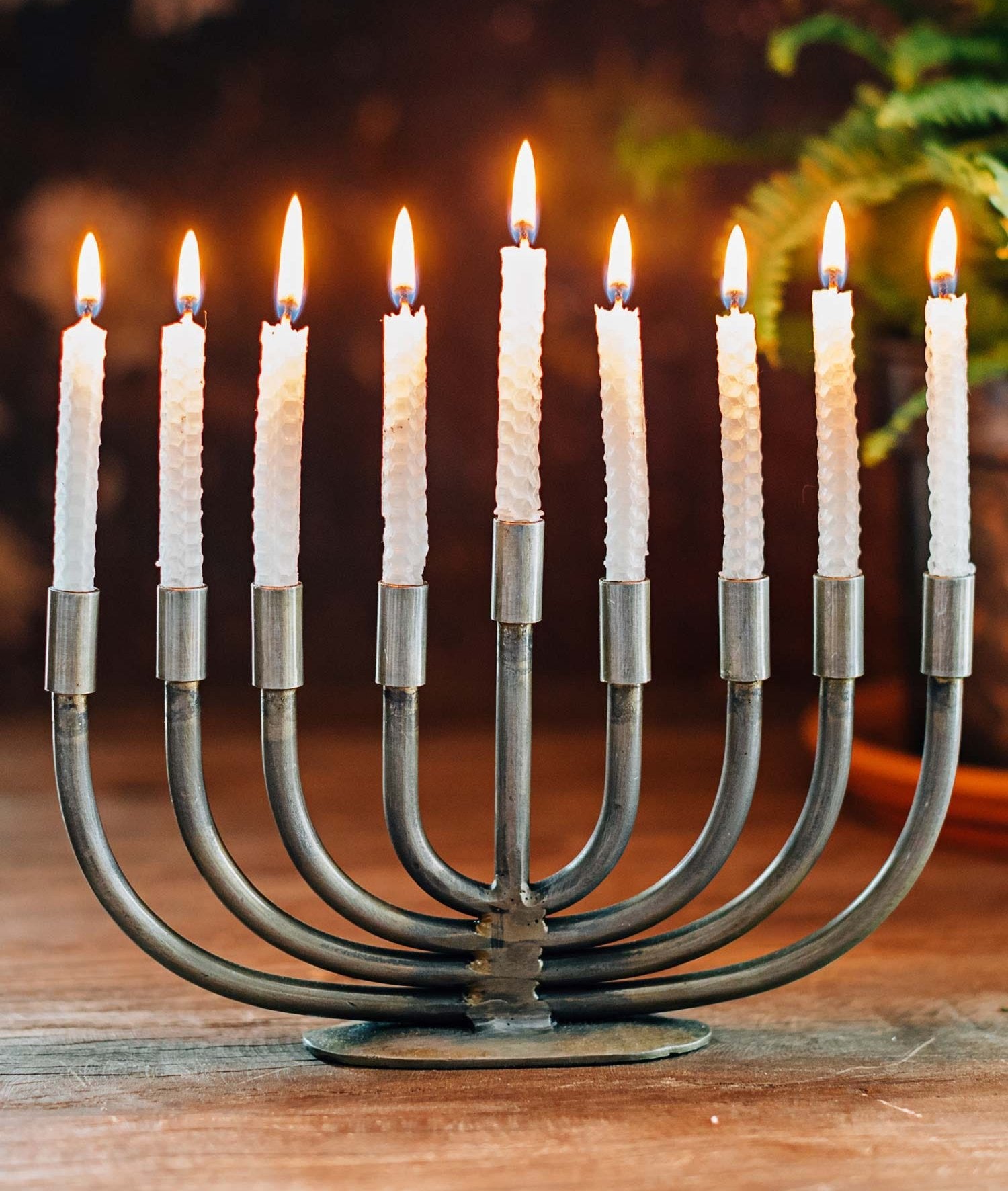 Front view of the handcrafted wrought iron menorah, showcasing its minimalist design and craftsmanship.
