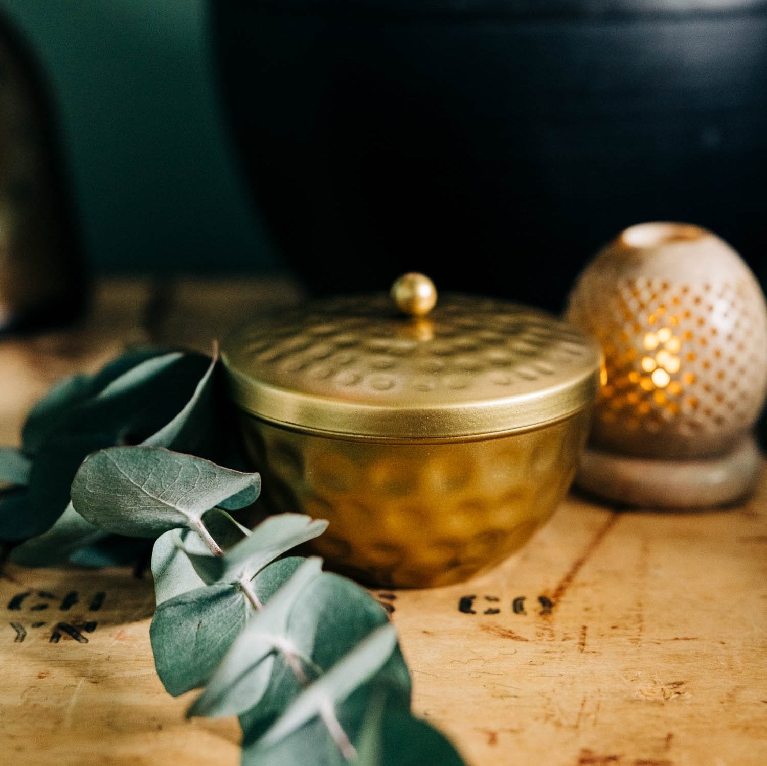 Elegant hammered jewelry tray showcasing a stylish design, placed on a bathroom counter.