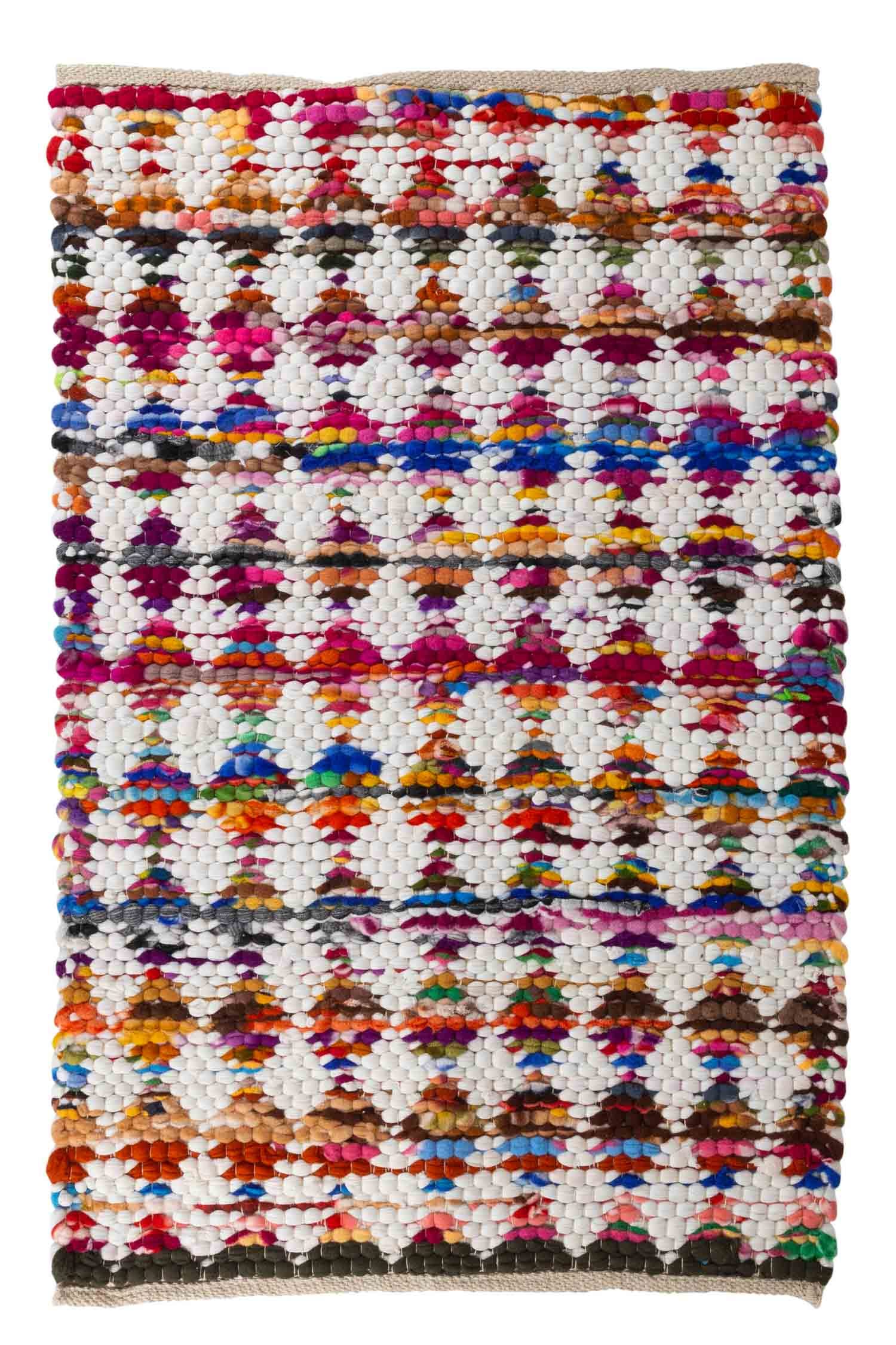 Overhead view of the colorful diamond rug by the entryway showcasing woven textures