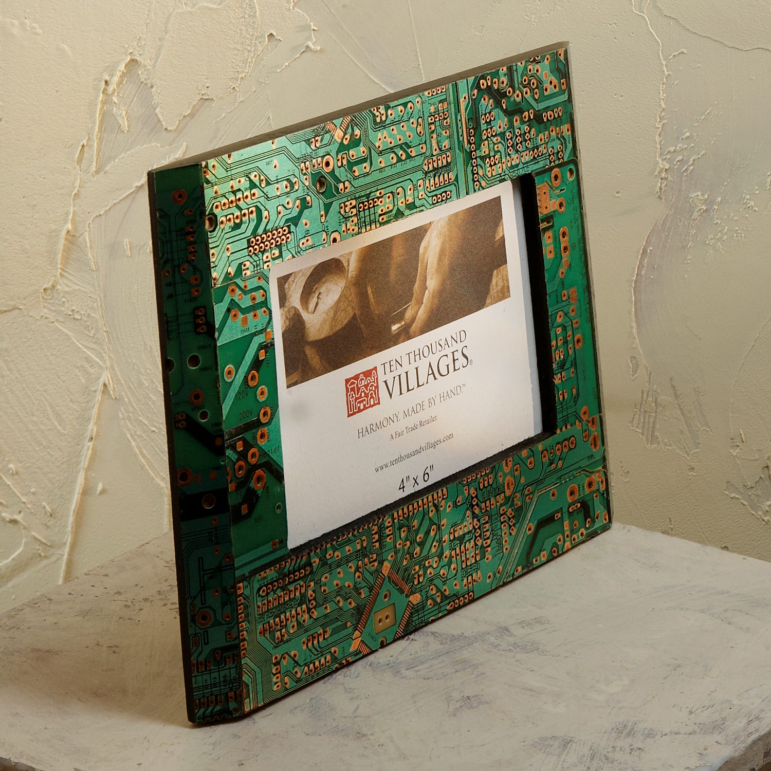 Artisan circuit board photo frame displaying a family picture in a modern living room setting.