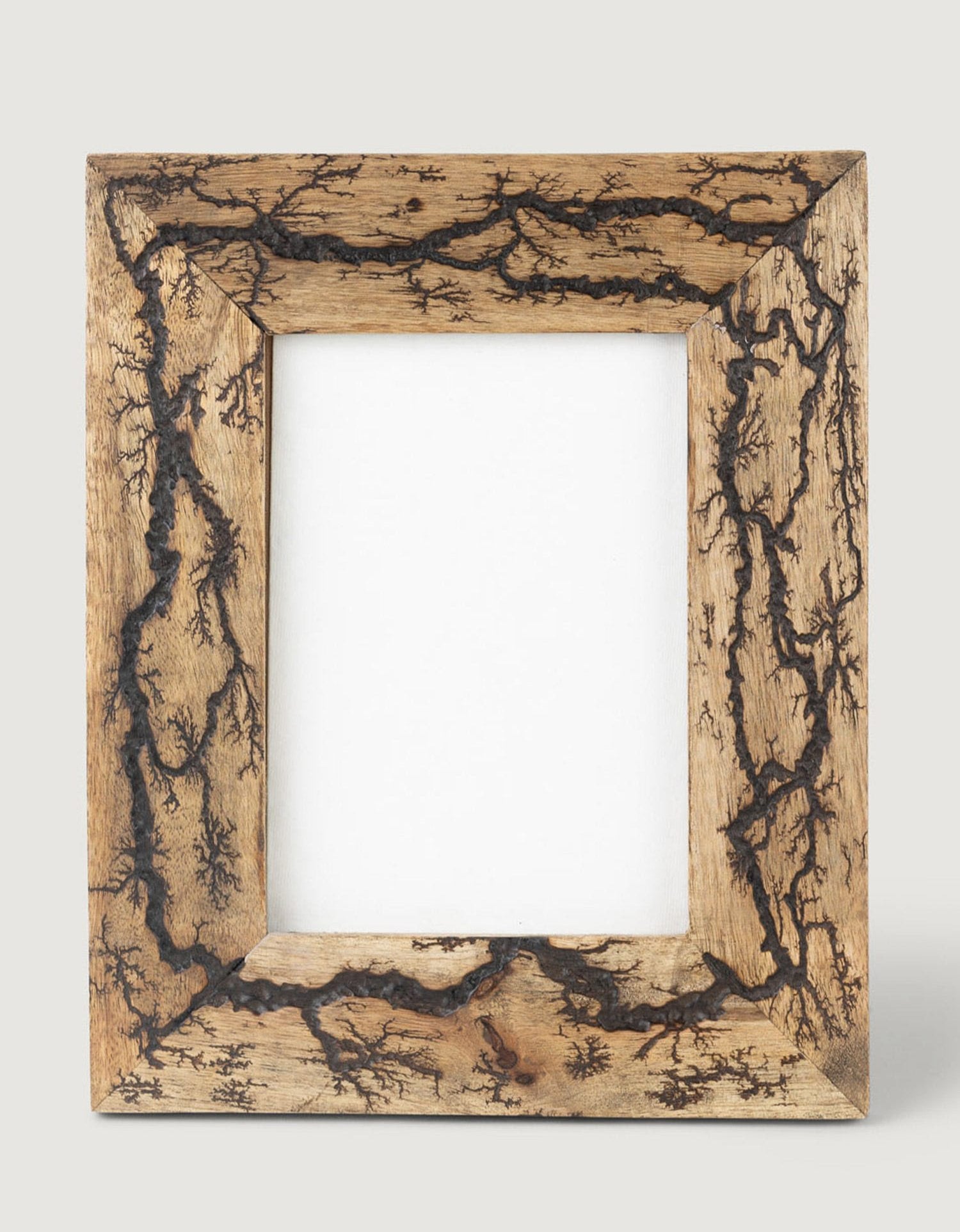 Close-up of intricate fractal lightning design on mango wood frame
