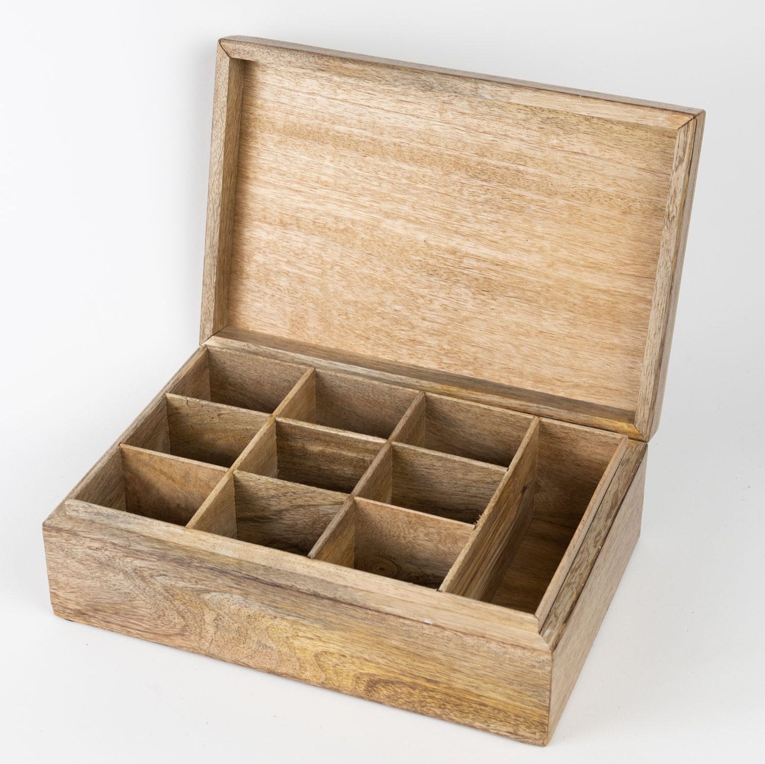 A top-down view showing the tea box's nine compartments filled with loose leaf blends