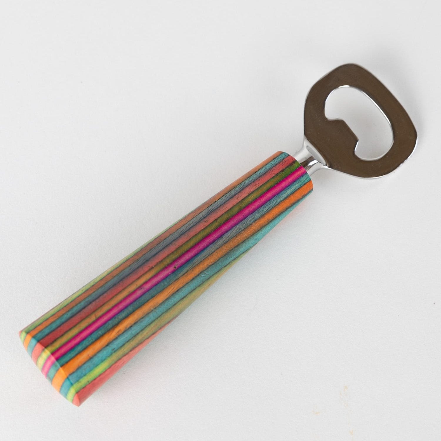 Close-up of striped wood bottle opener showing vibrant patterns and tapered handle
