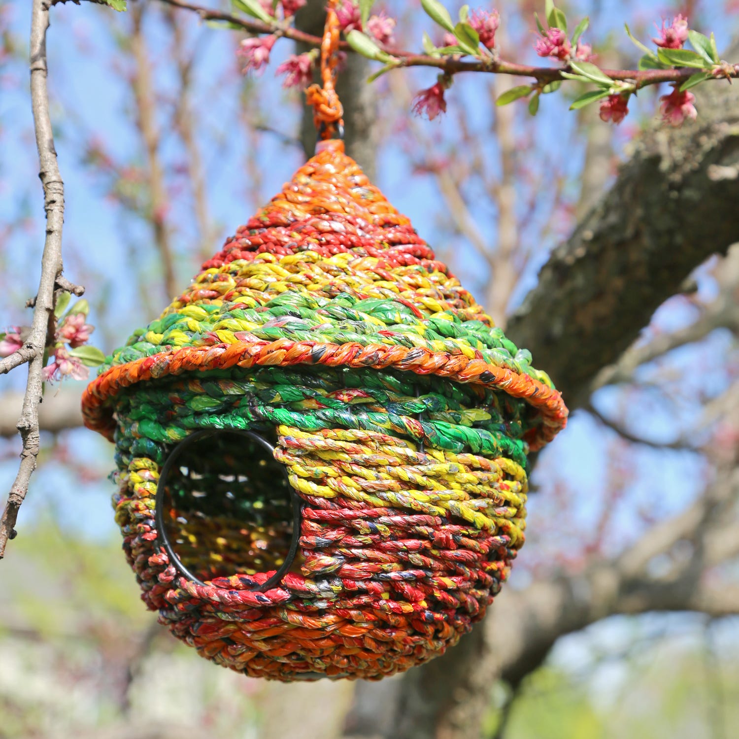 Close-up of the eco-friendly handcrafted birdhouse showing recycled snack wrappers and wire details