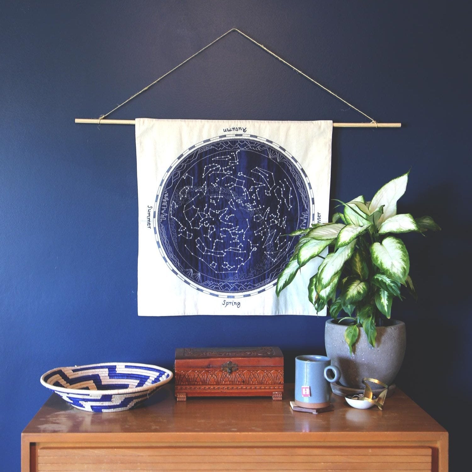 Close-up view of hand-embroidered star wall art for living room, displaying intricate details.