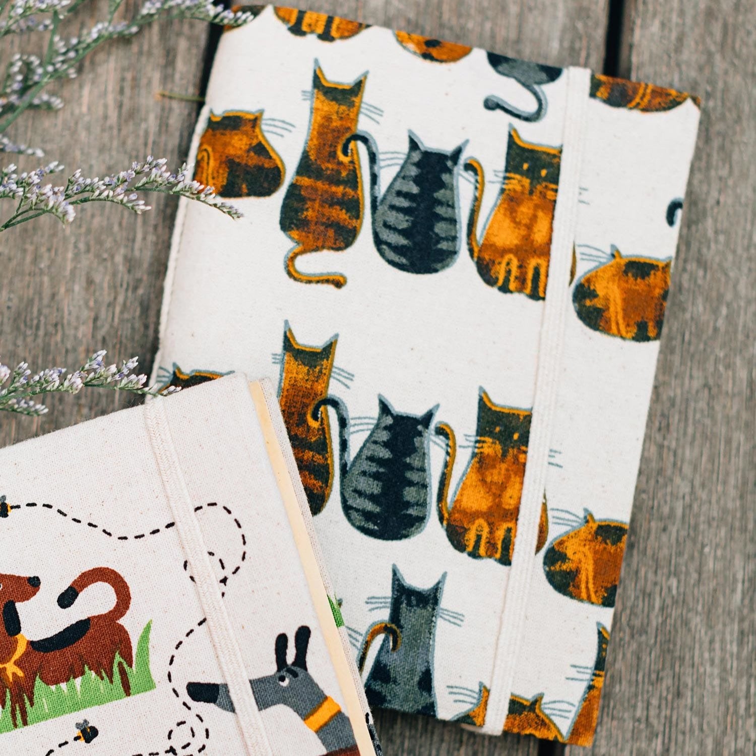 Close-up of a handcrafted cat journal with whimsical feline artwork, ideal for pet lovers