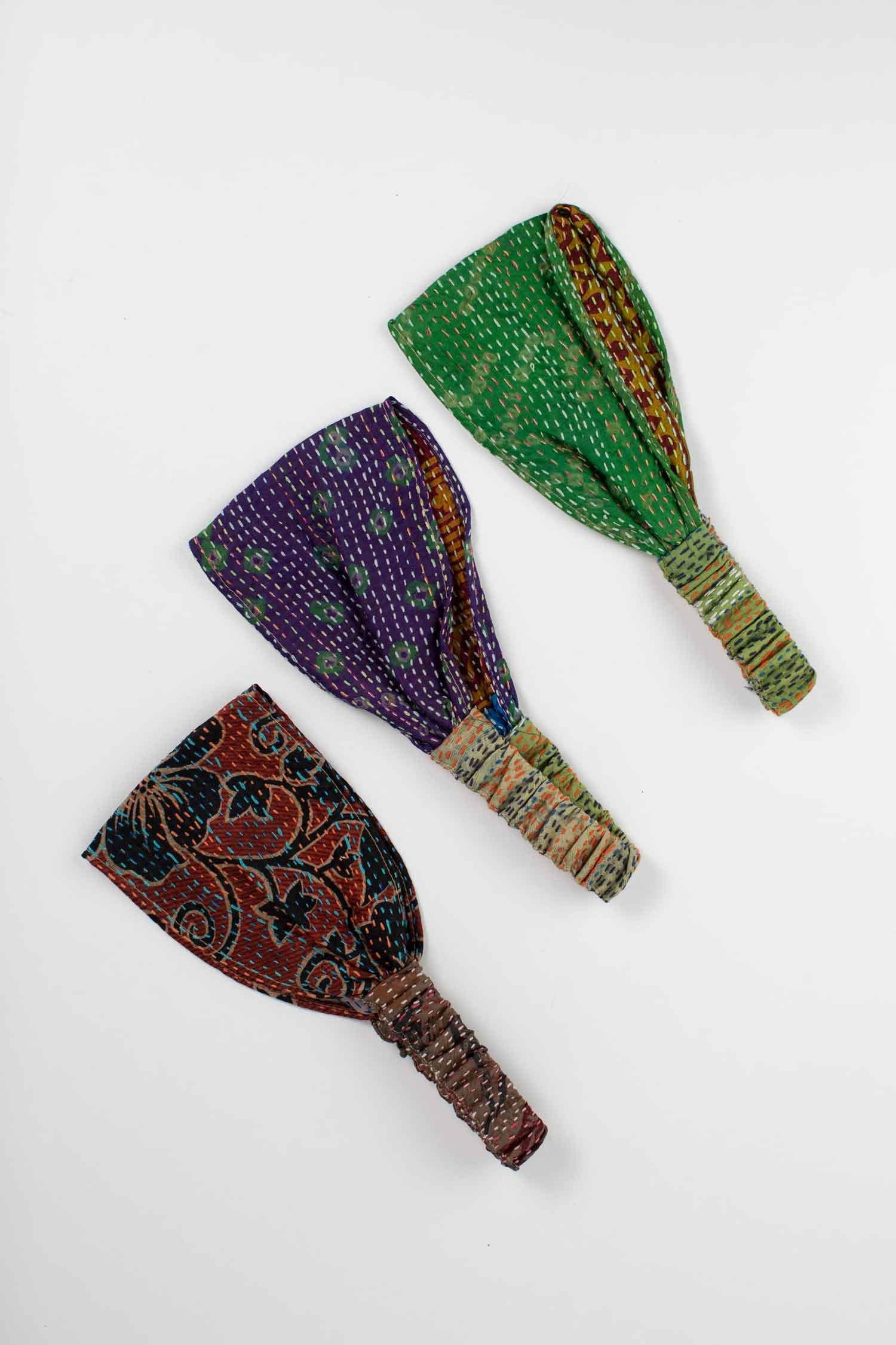 Close-up of a handmade recycled silk headband showcasing vibrant patterns