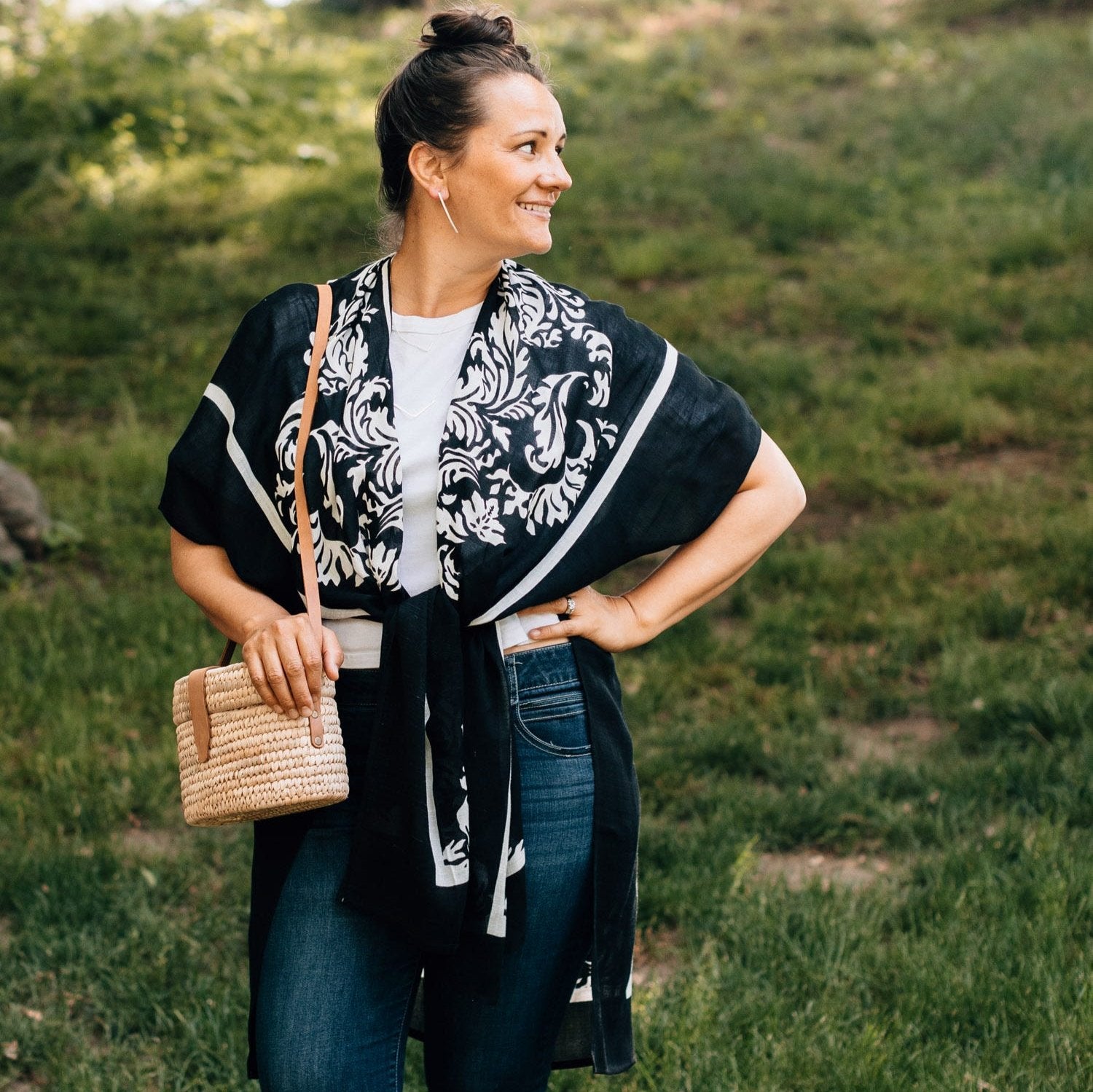 Chic black and white beach cover up draped over a beach chair, perfect for summer days.