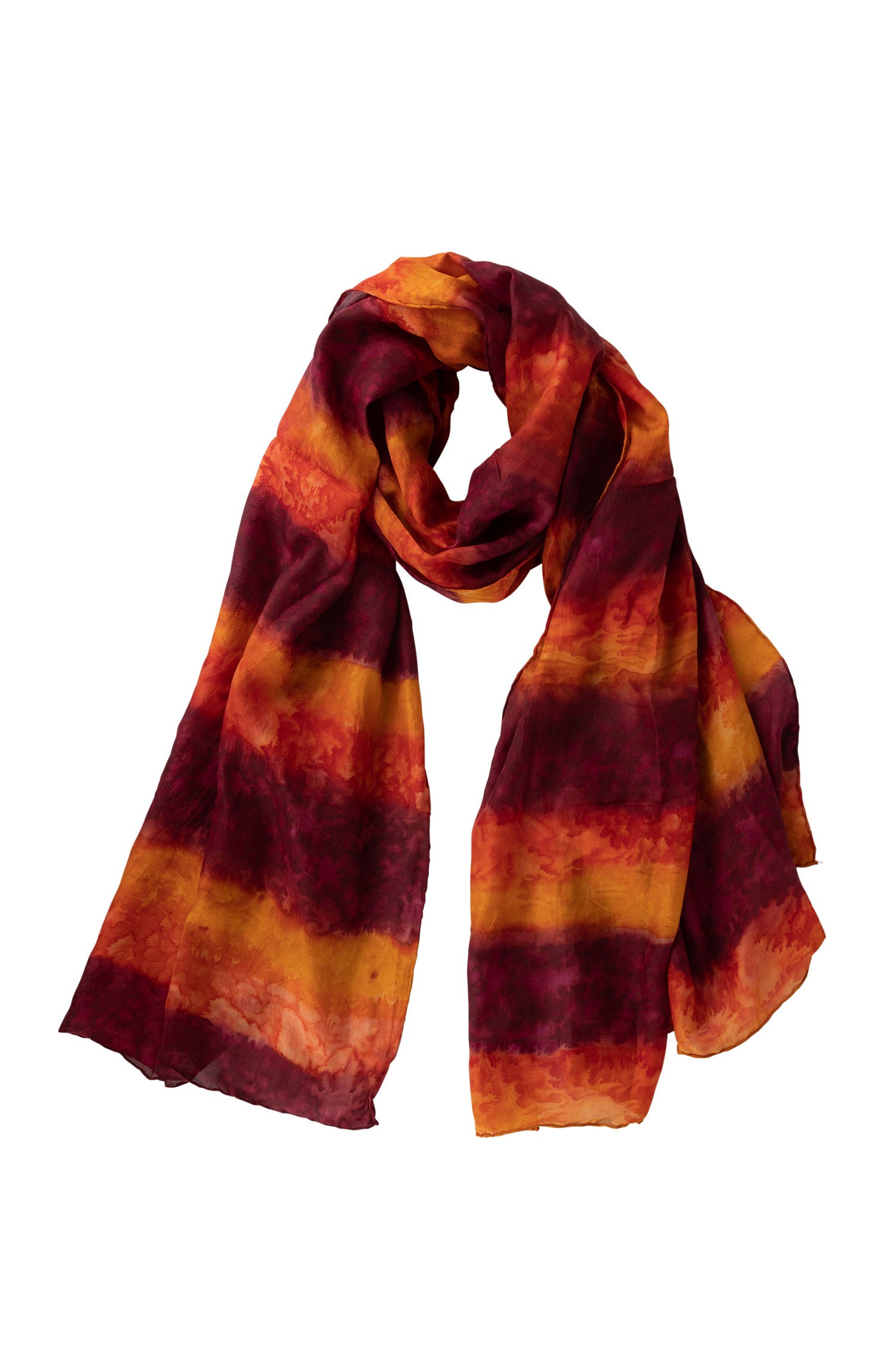 Handcrafted silk scarf draped over a chic outfit, showcasing its vibrant tie-dye pattern.