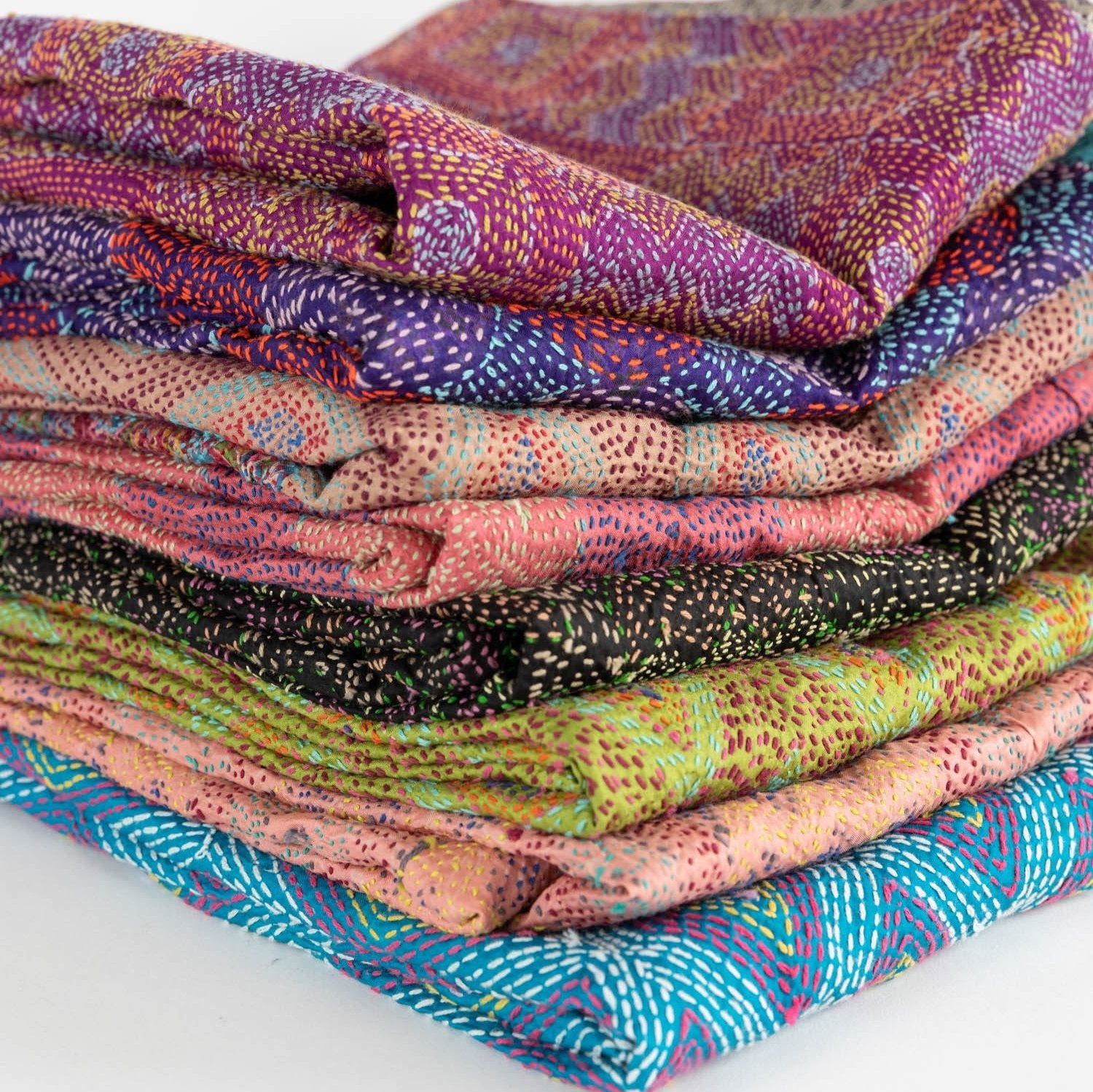 Close-up of the artisan luxury handstitched silk scarf, highlighting its intricate patterns and textures.