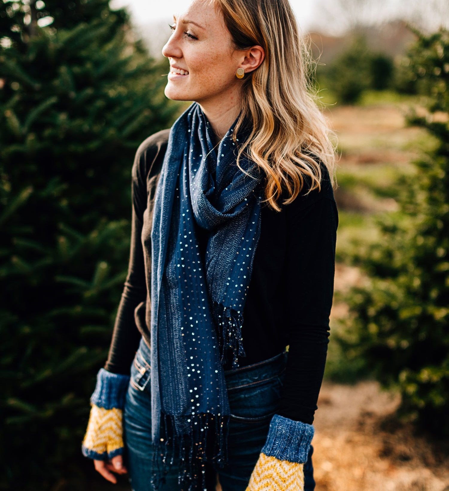 Fashionable woman wearing a celestial constellation scarf showing off its galaxy pattern