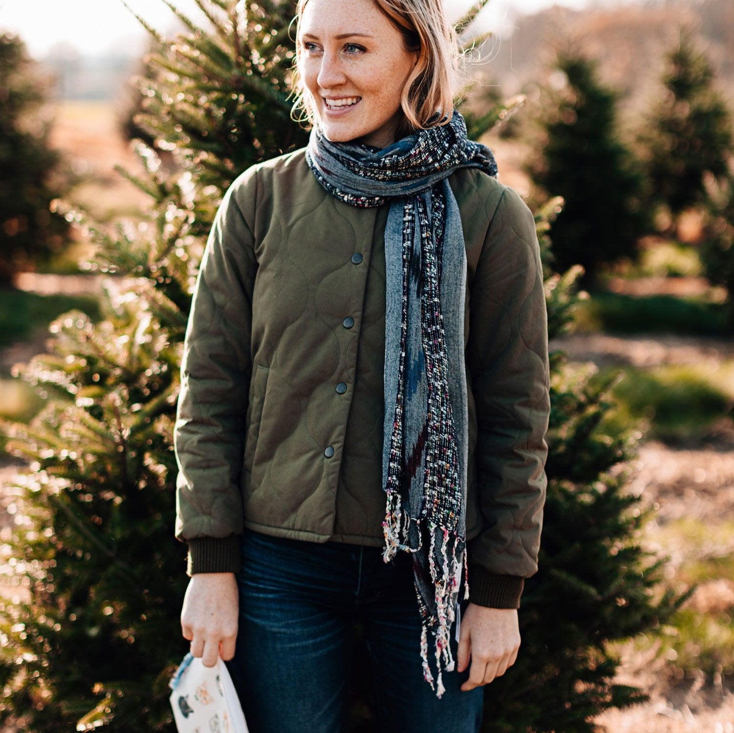 Vibrant Confetti Stripe Scarf draped elegantly over a winter coat.