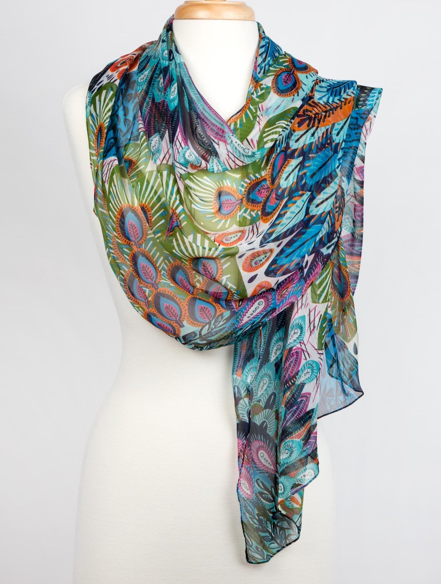 Close-up of the peacock scarf showing hand-stitched detailing and vibrant colors