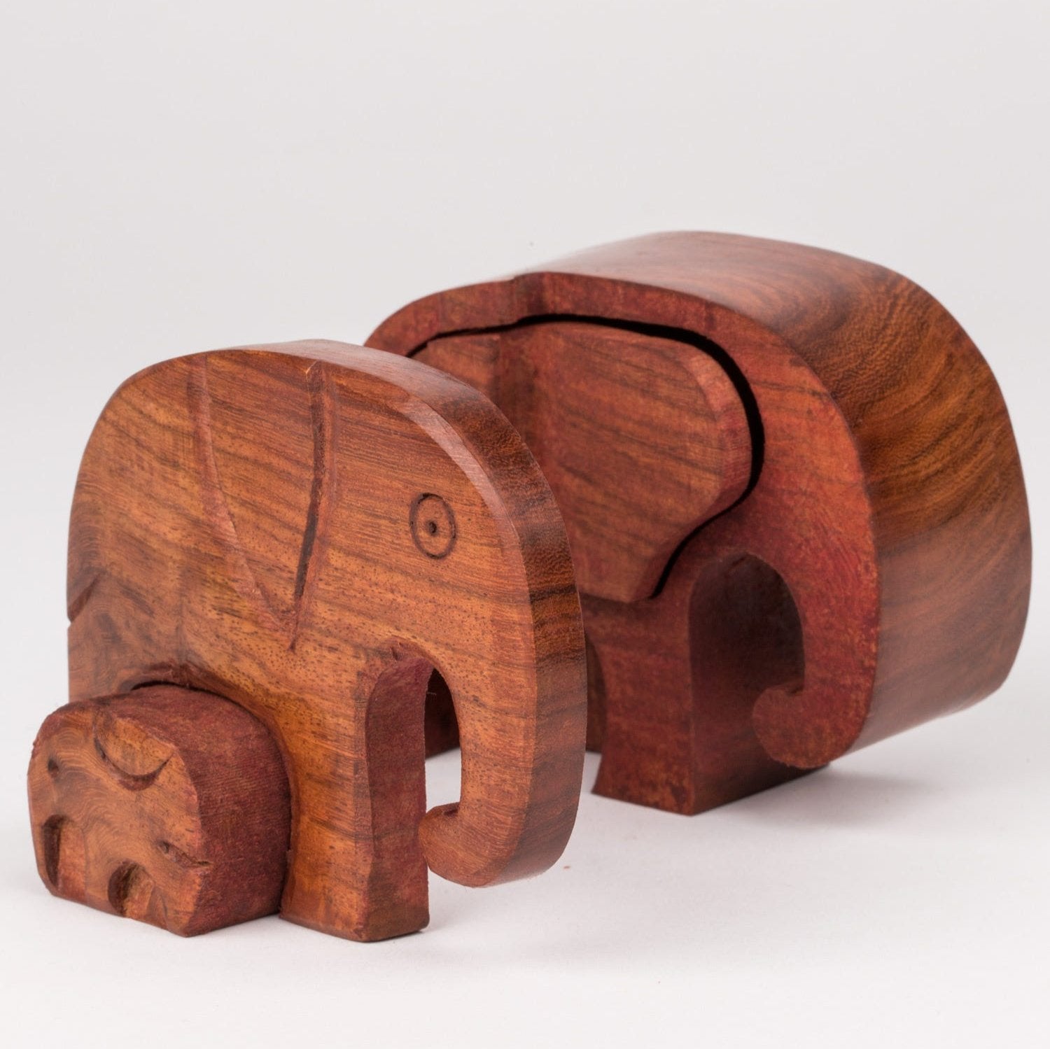 Handcrafted elephant puzzle box showing intricate carvings of mother and baby elephants, ideal for home decor.