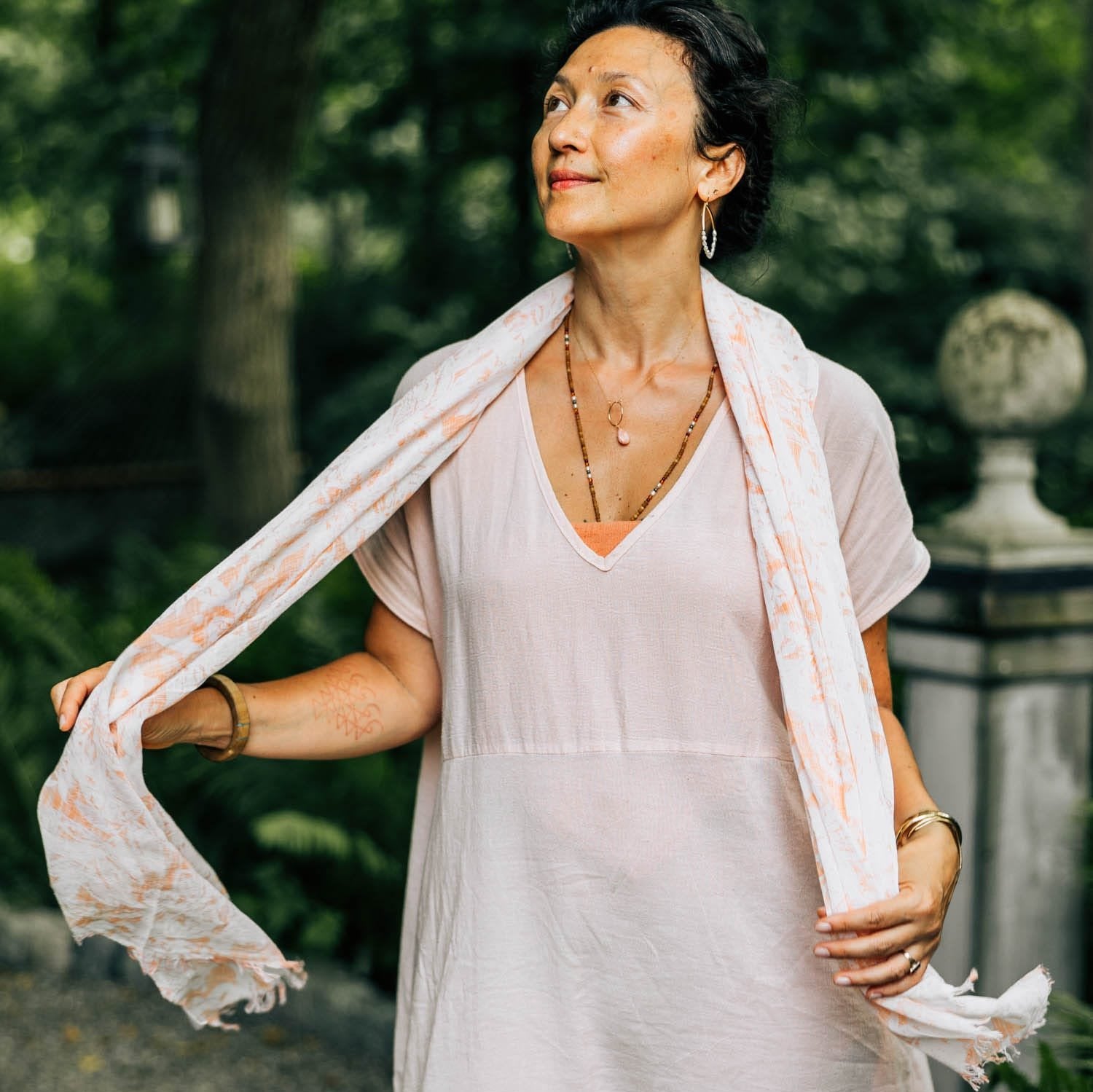 Front view of the lightweight orange cotton scarf with floral pattern