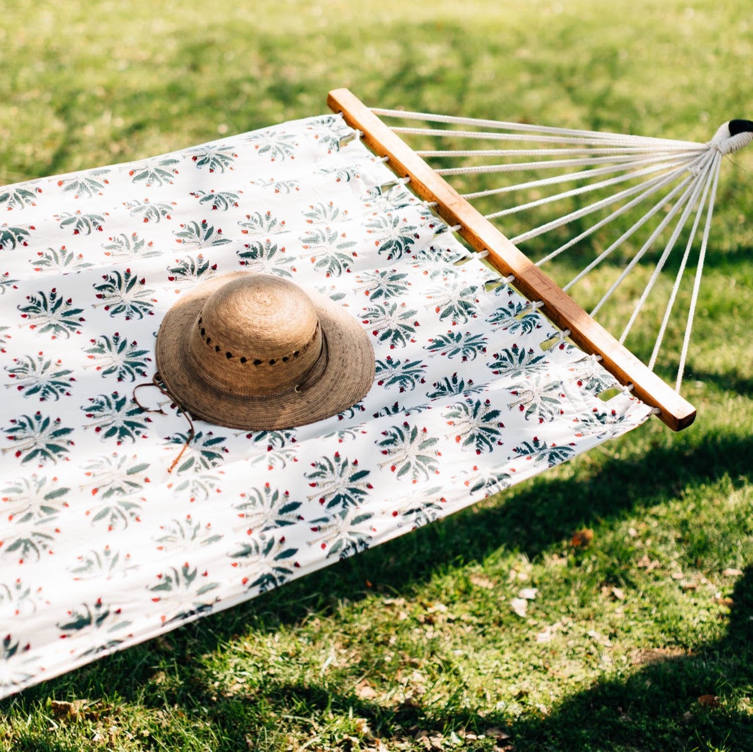 Close-up of hand-printed palm tree pattern on cotton hammock for patio