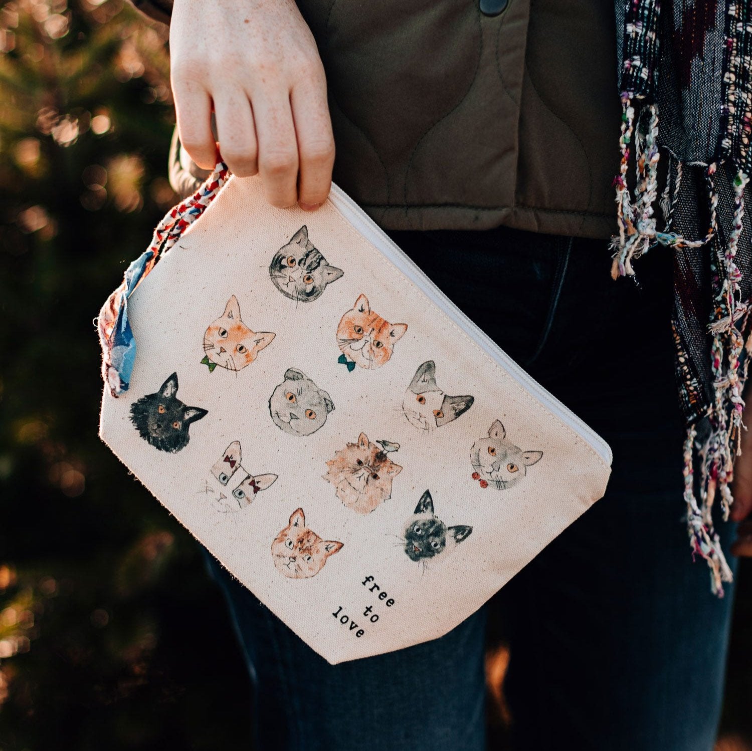 Front view of handmade pouch for cat lovers with tassel detail