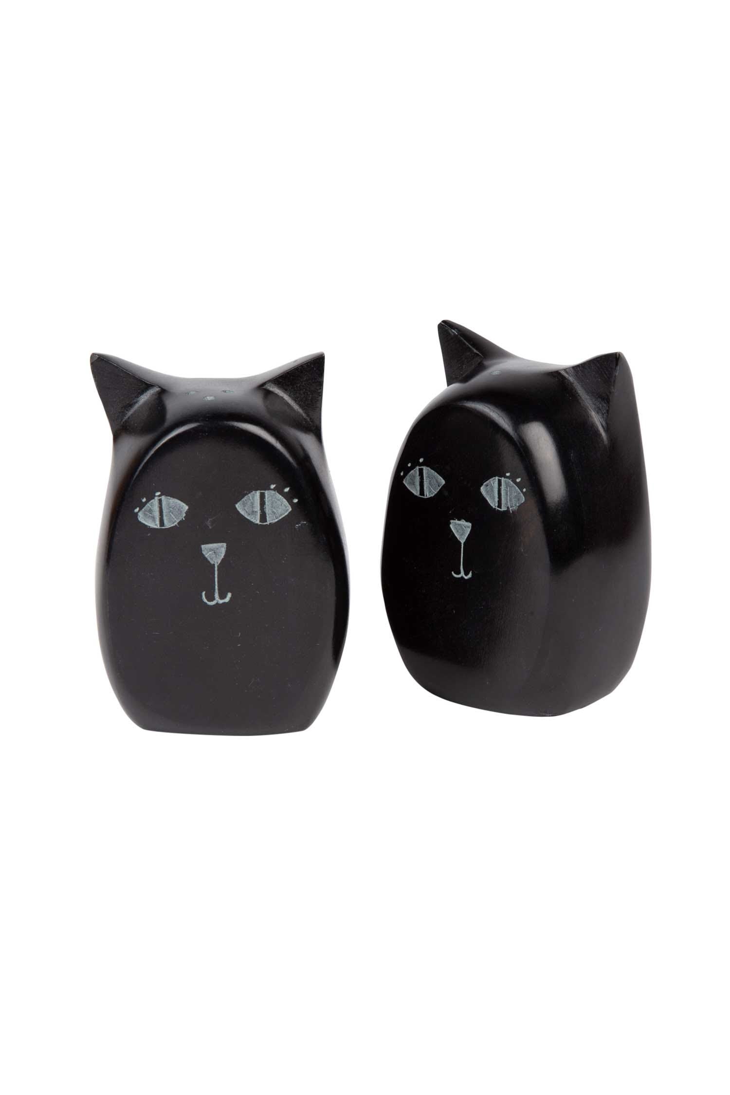 Handcrafted black cat salt and pepper shakers on a kitchen table