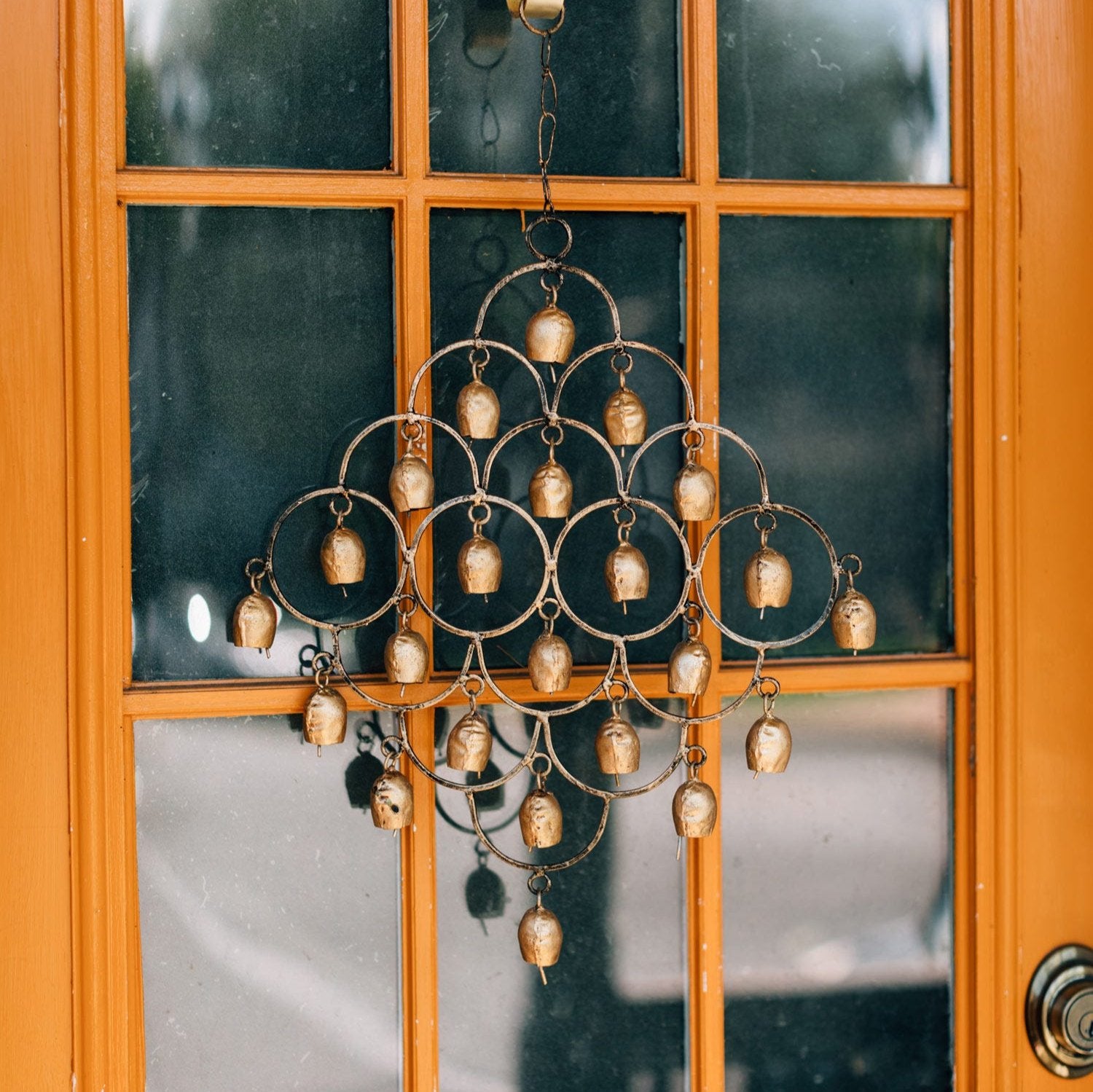 Close-up of 23 iron bells on the wind chime, showing textured metal details