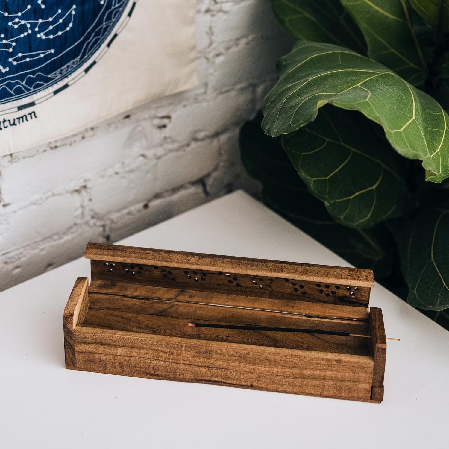 Close-up of handcrafted acacia wood incense box with intricate lid design