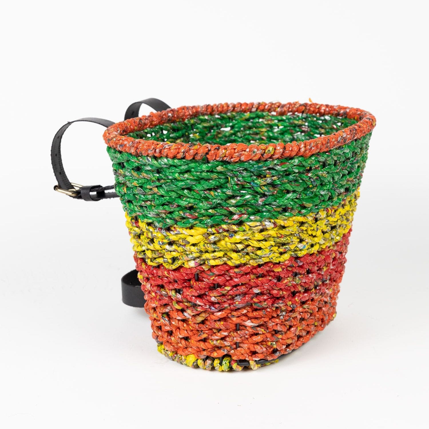 Eco-friendly bike basket attached to a bike handlebar, perfect for shopping trips.